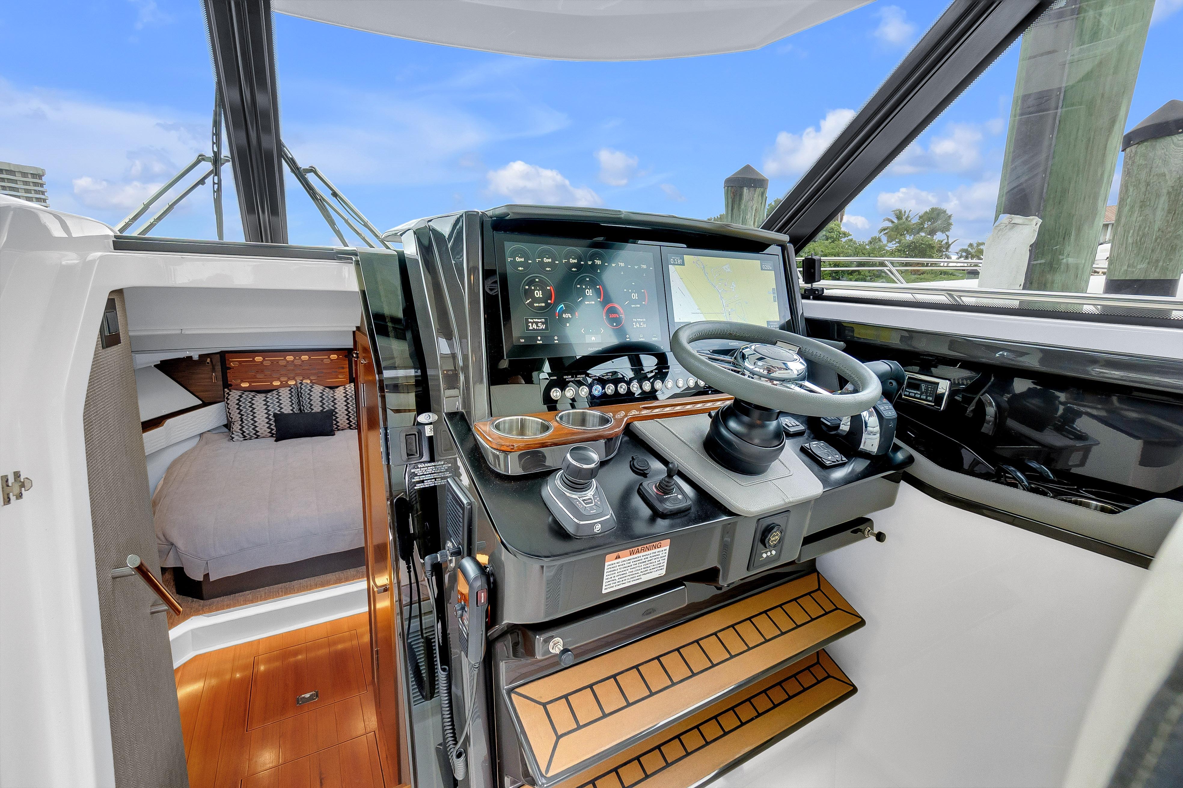 2021 Tiara Sport 43 LE yacht helm with modern controls and cozy cabin interior.
