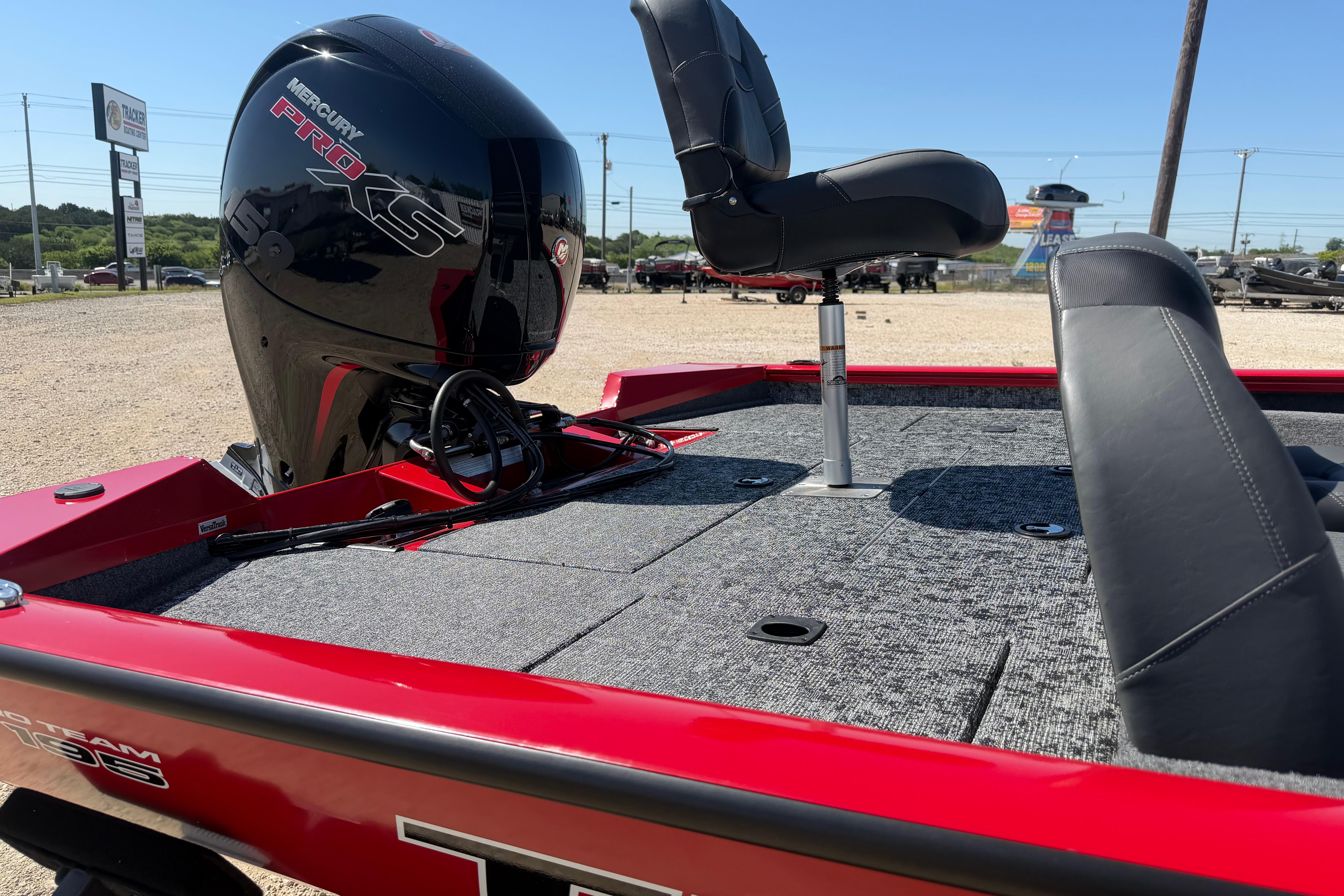 2026 Tracker Pro Team 195 boat with Mercury Pro XS engine, red exterior, and seating.