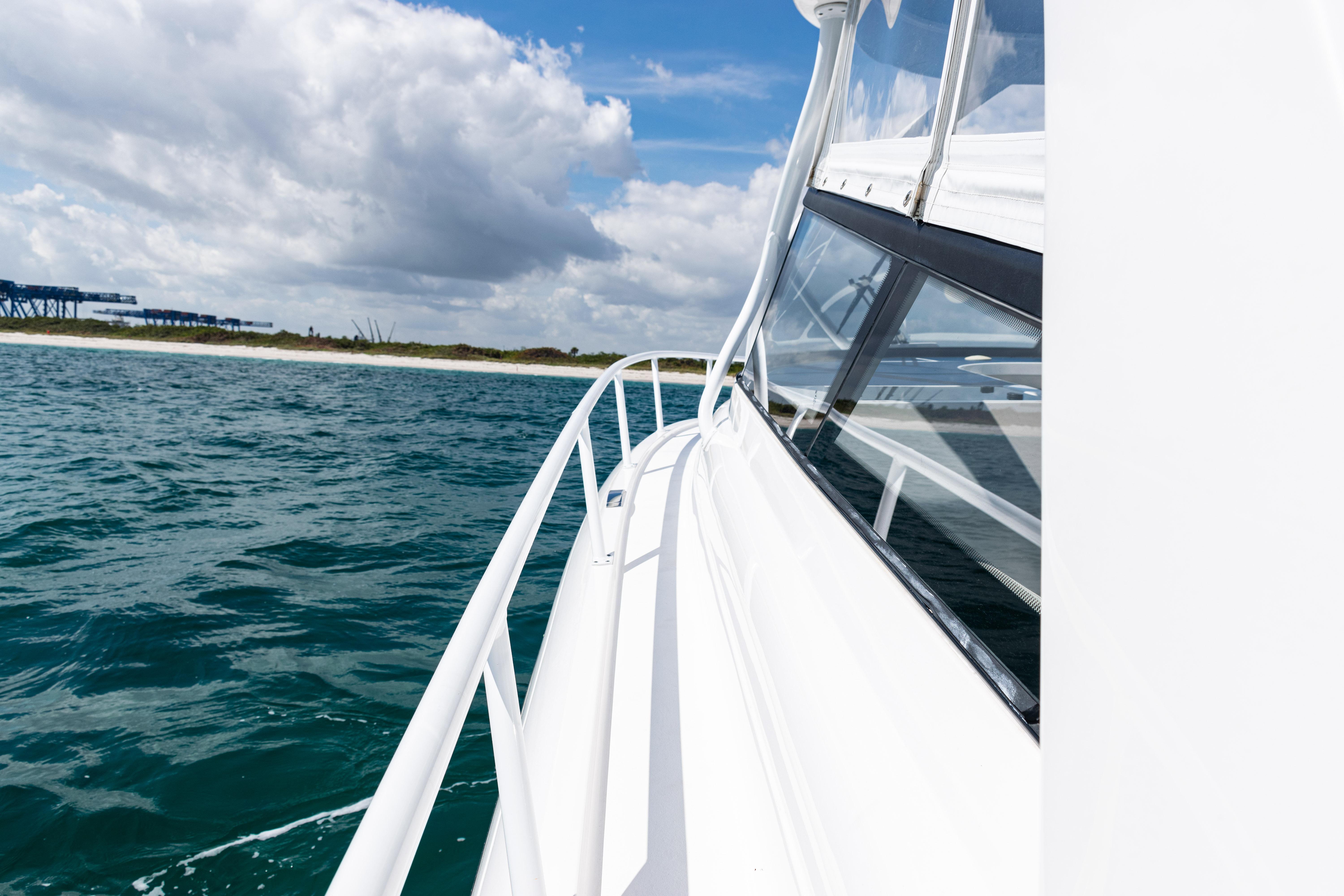 2018 Intrepid 438 Evolution yacht cruising on open water under a cloudy sky.