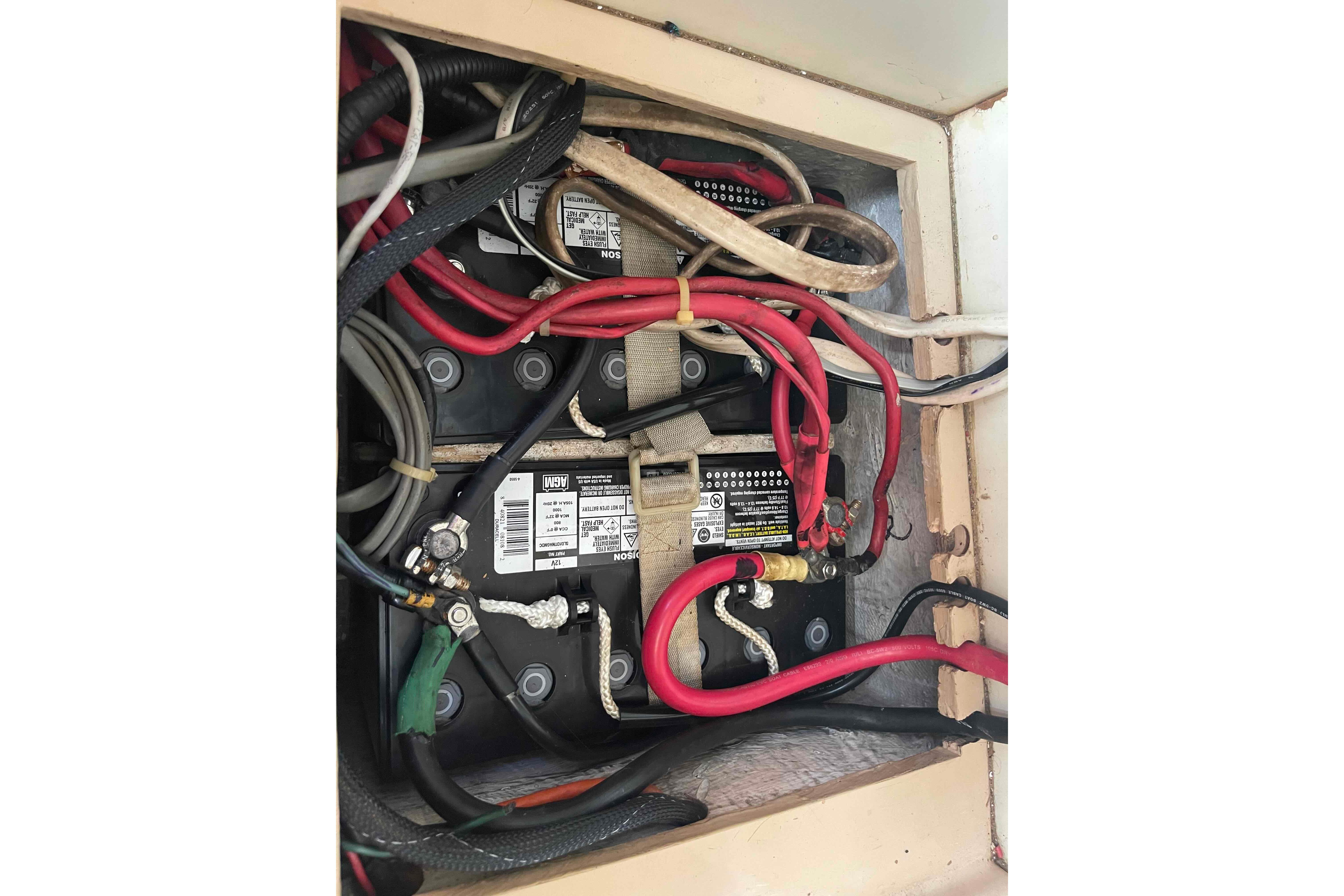 Battery compartment with wiring in a 1989 Island Packet 35 sailboat.