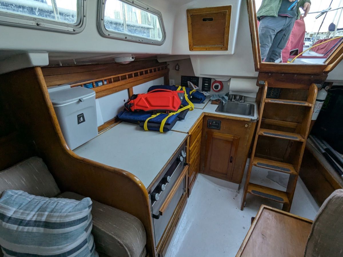 Interior of a 1984 Ericson 35 with a galley and seating area.