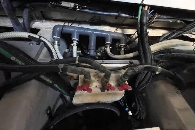 Engine compartment of a 2016 Sea Ray Sundancer 510 with visible hoses and wiring.