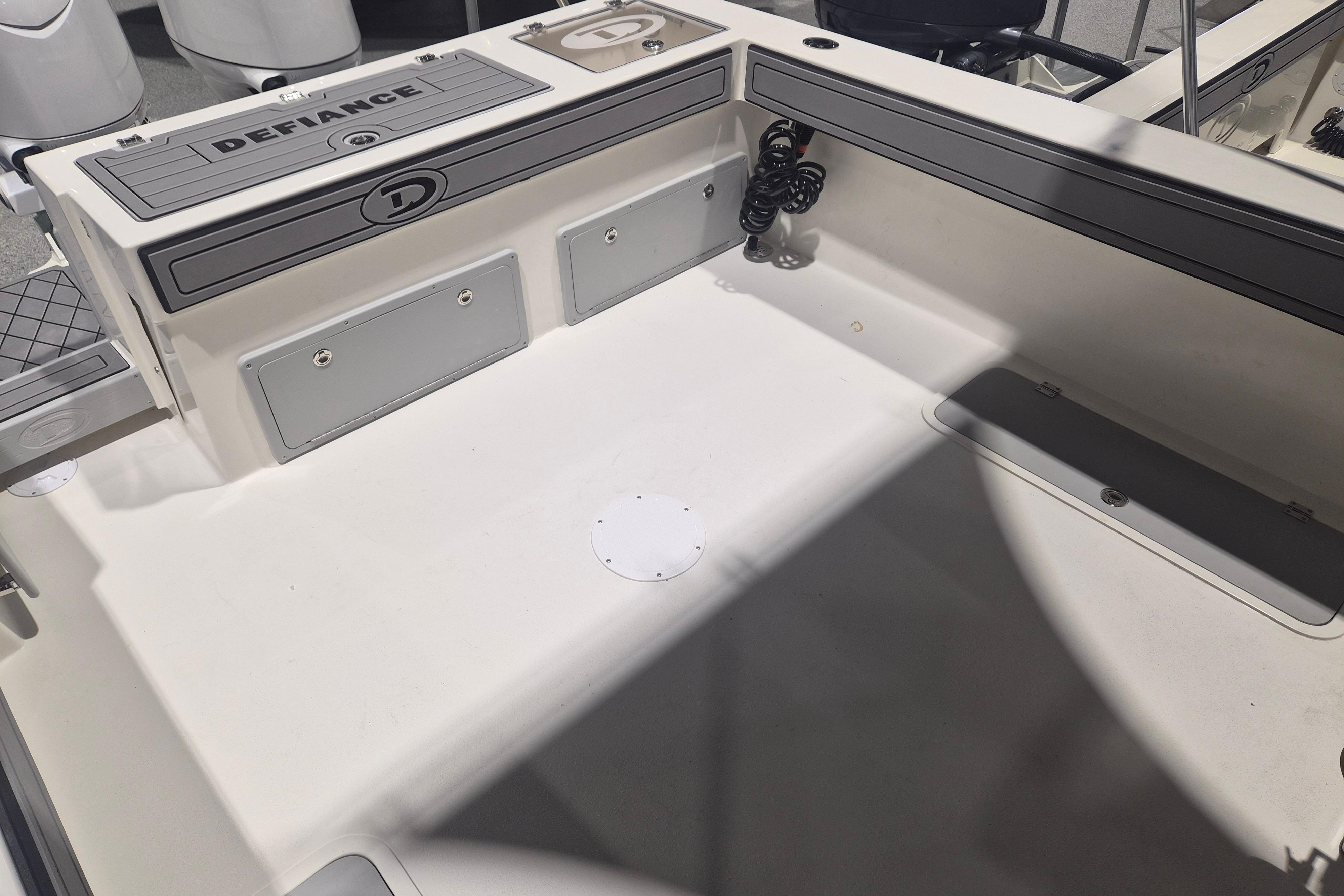 2026 Defiance Admiral 260 EX boat deck, featuring storage compartments and sleek design.