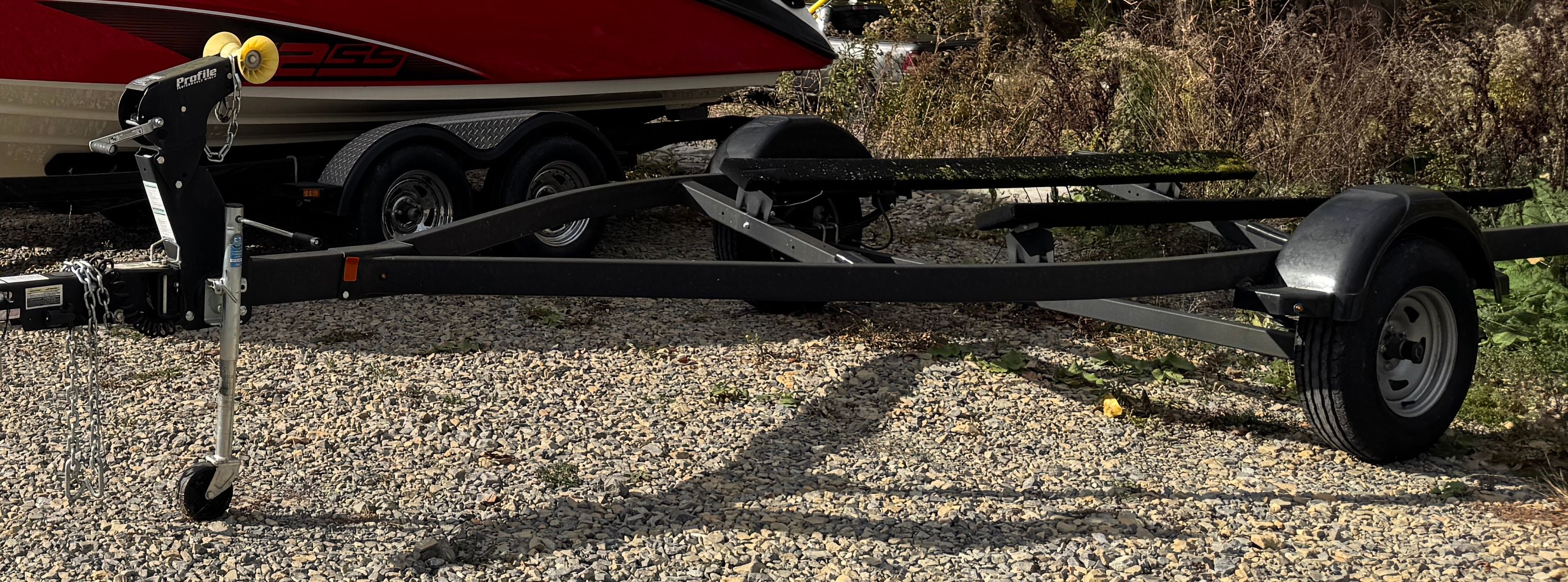 Boat trailer for 2020 Yamaha SX190 on gravel surface.