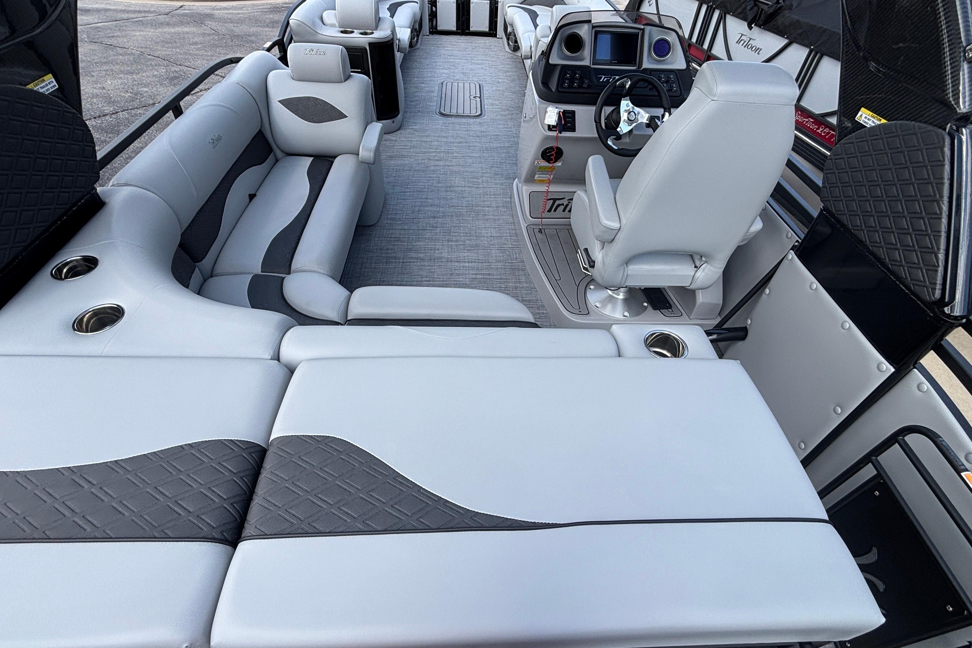 Luxurious interior of 2026 JC NEPTOON 27TT SPORT pontoon boat with plush seating and modern helm.