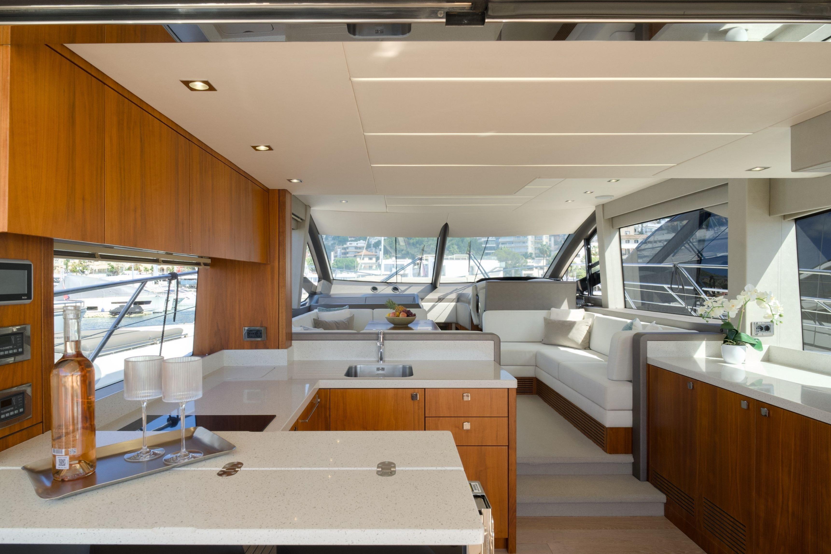 Luxurious interior of 2019 Sunseeker Manhattan 52 yacht with modern kitchen and seating area.