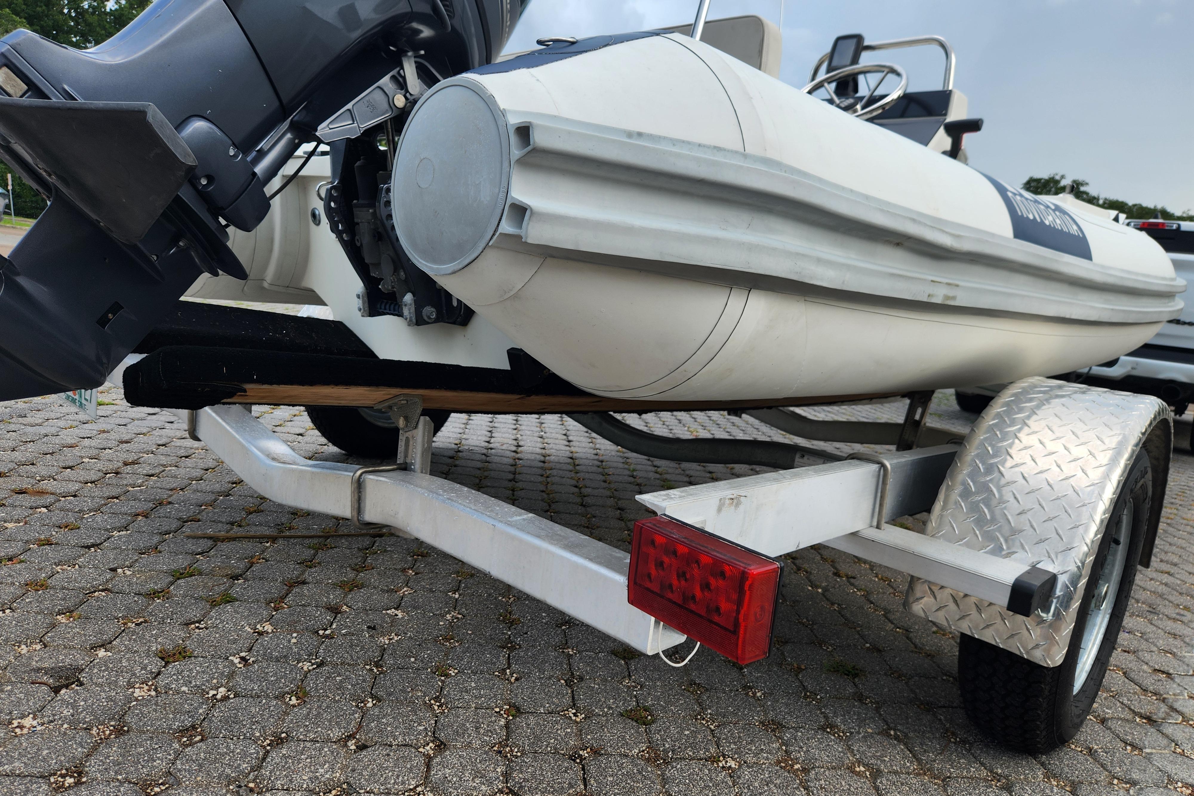 2019 Novurania DL 400 boat on trailer, featuring outboard motor and diamond plate fender.