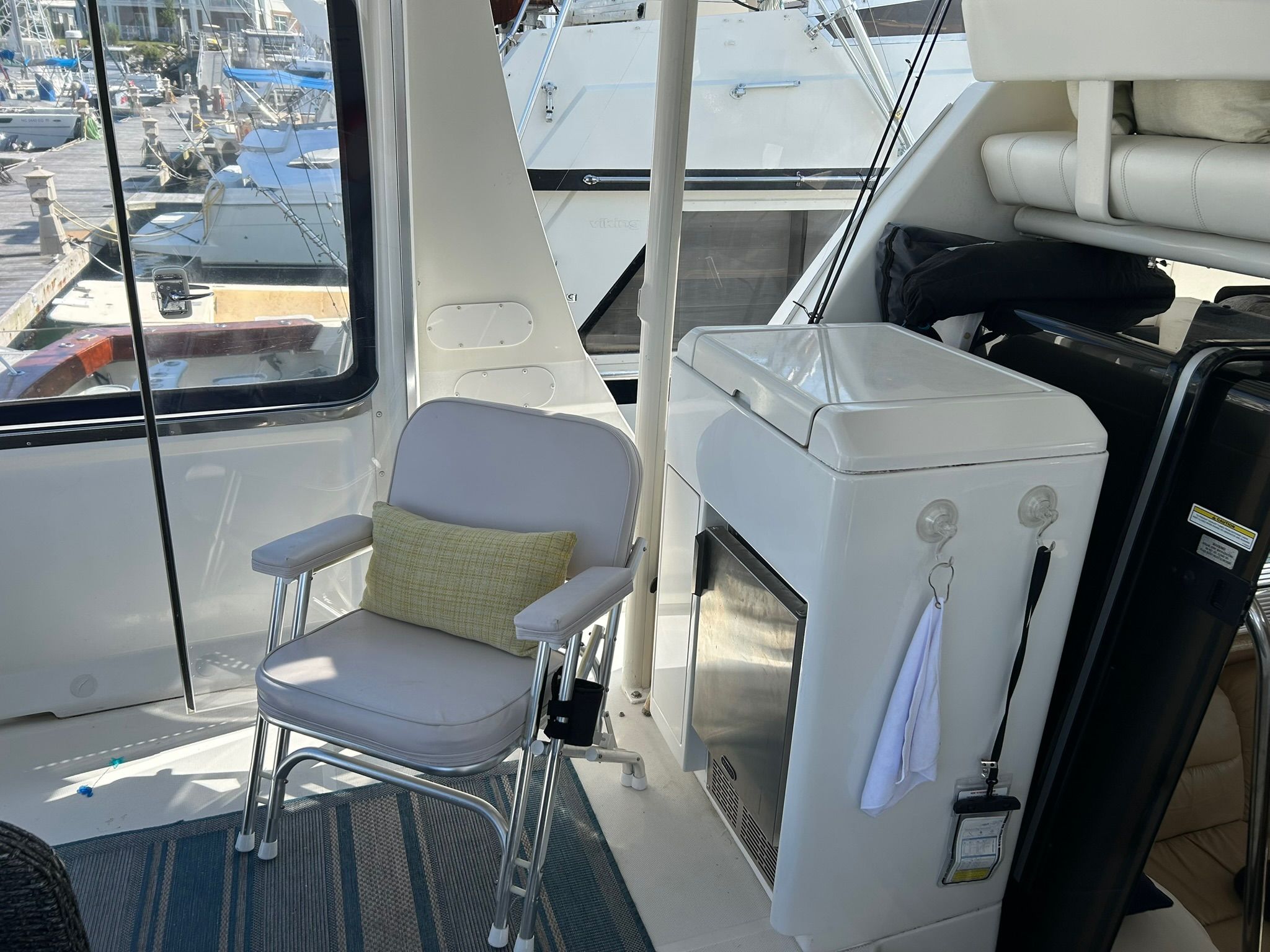 Interior of Carver 356 yacht with chair and fridge.
