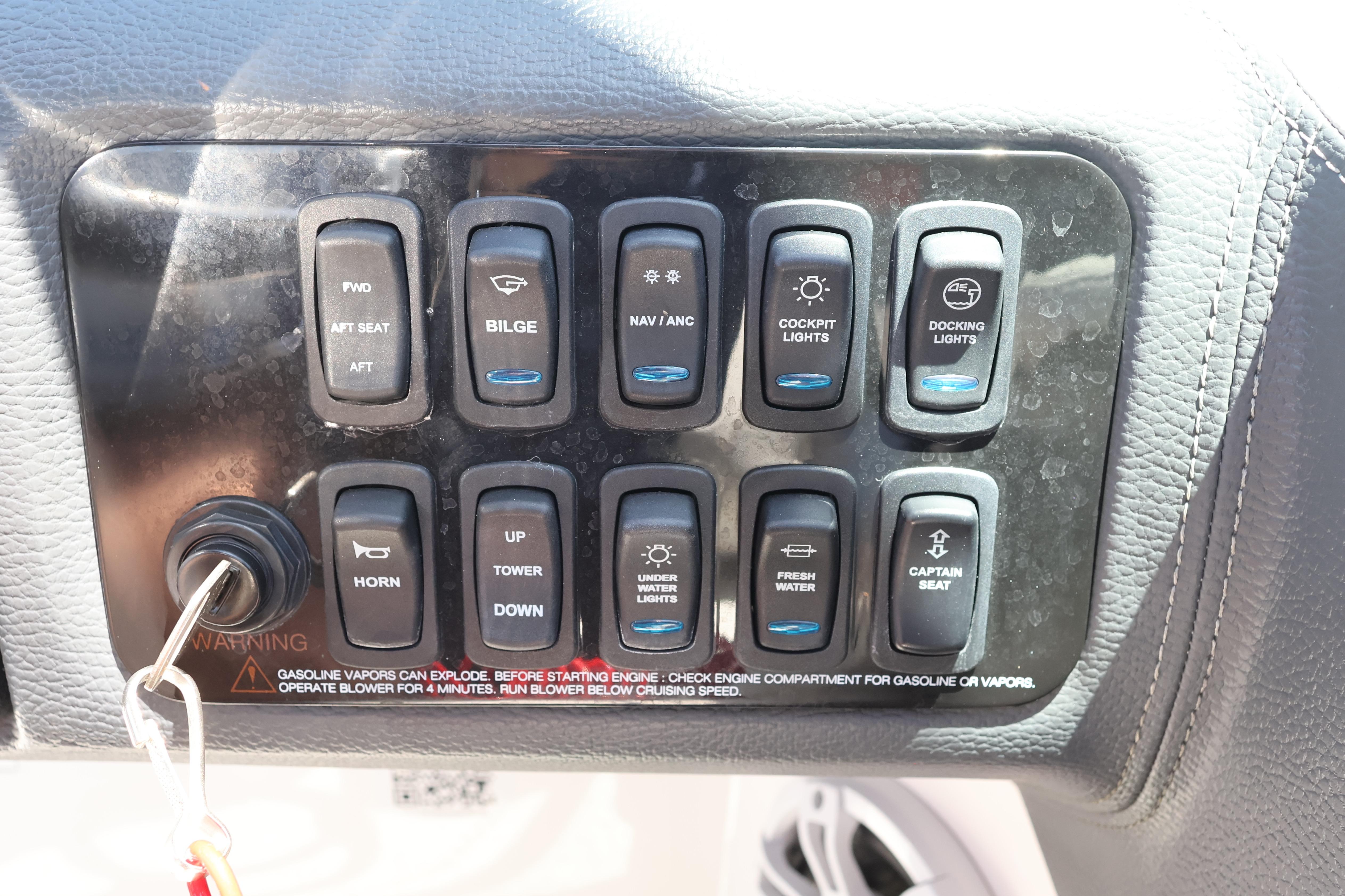 Control panel of a 2020 Regal LX4 boat with various switches and ignition key.