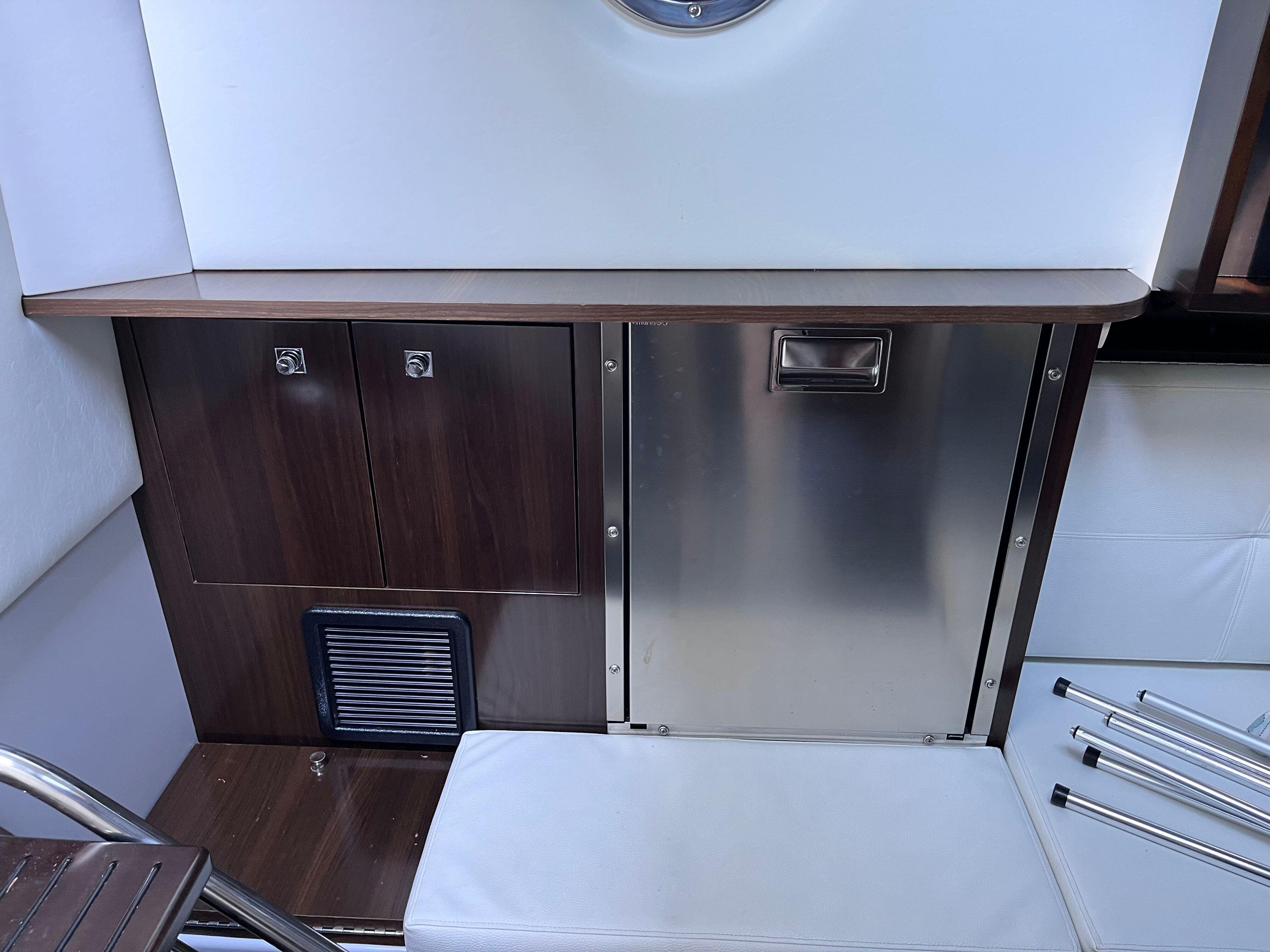 Interior of 2021 Cruisers Yachts 338 CX IO, featuring sleek cabinetry and stainless steel accents.