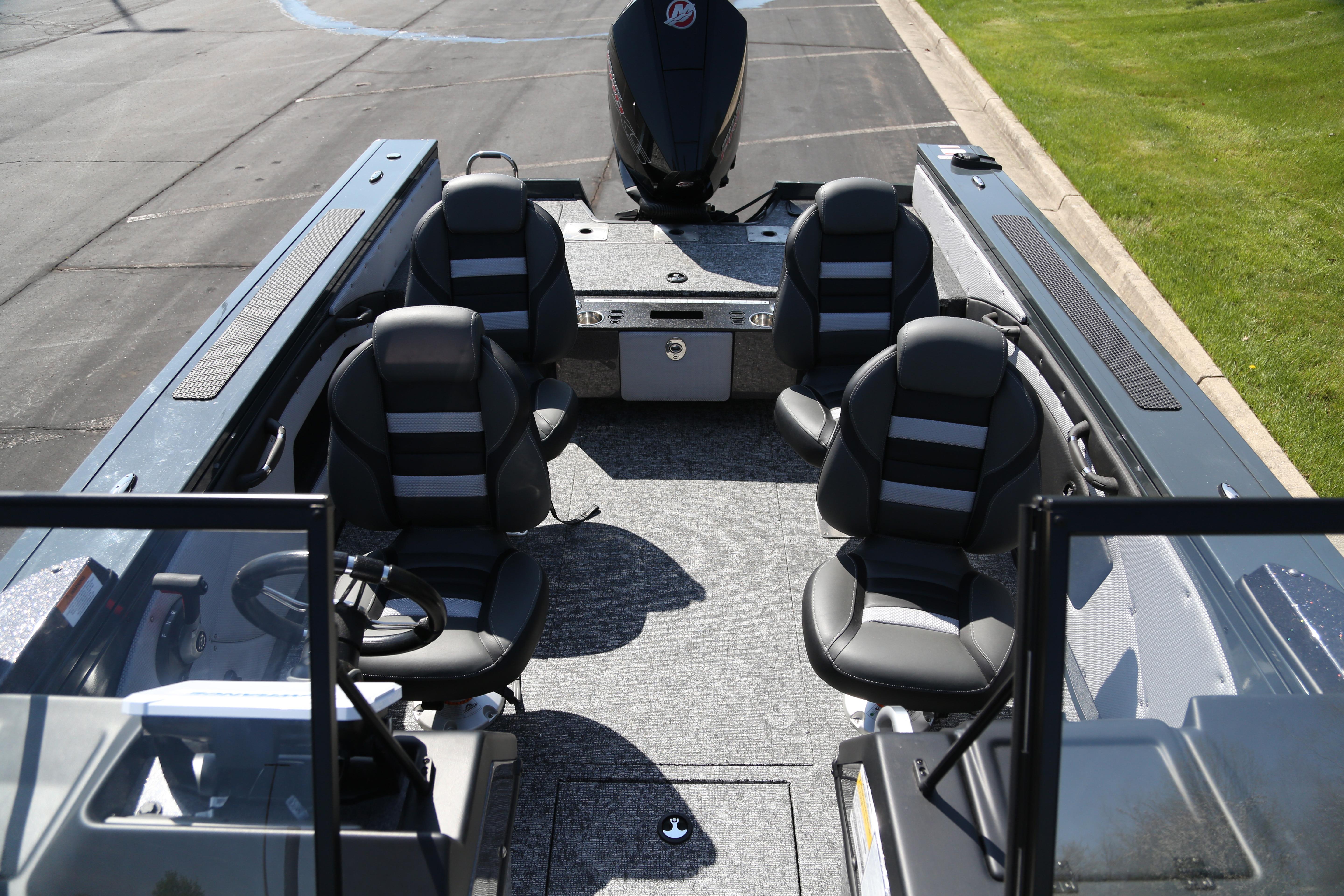 2026 Ranger VX1888 WT boat interior with seating and steering wheel, parked on pavement.