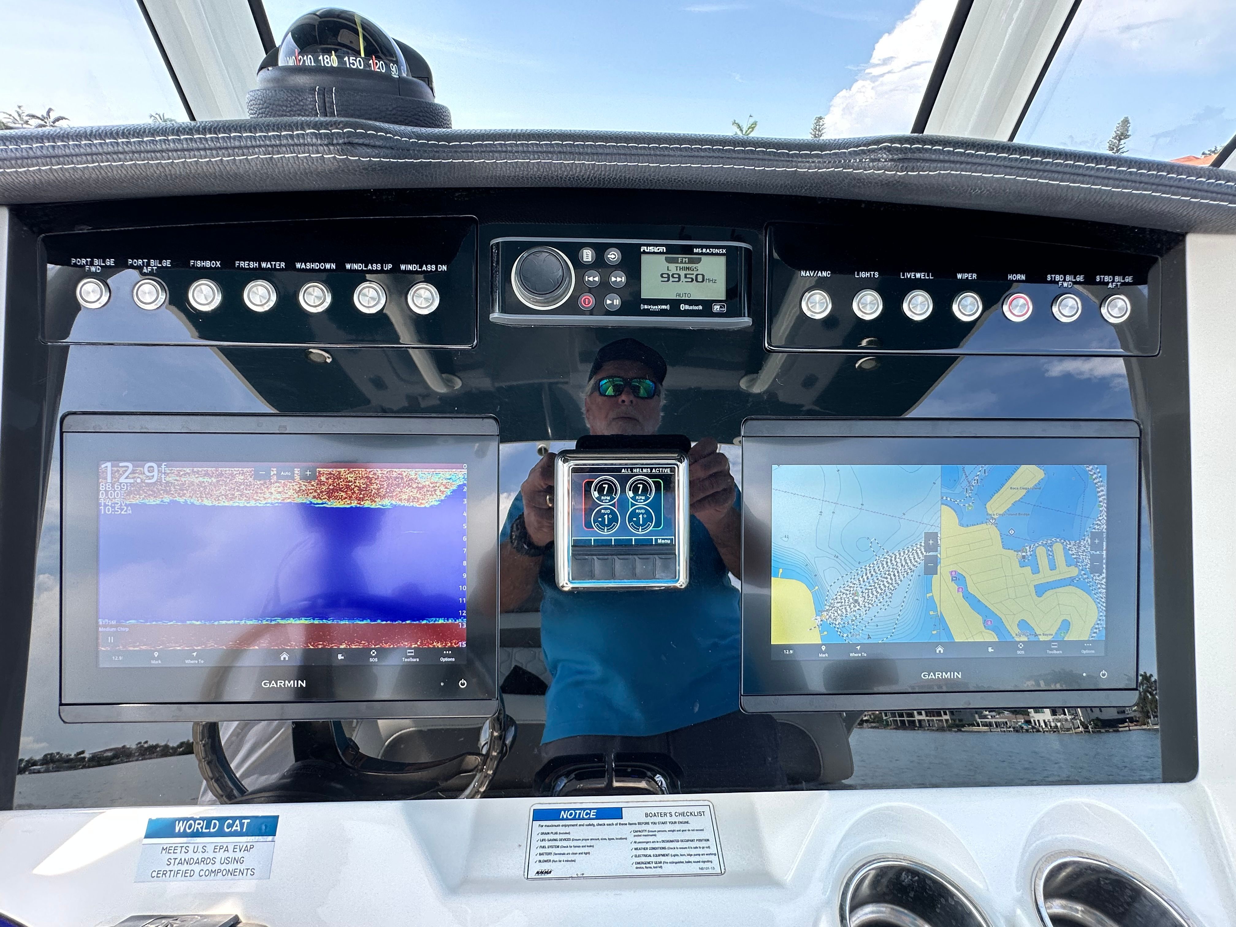 The image shows the helm of a World Cat 280 CC-X boat with modern navigation systems.