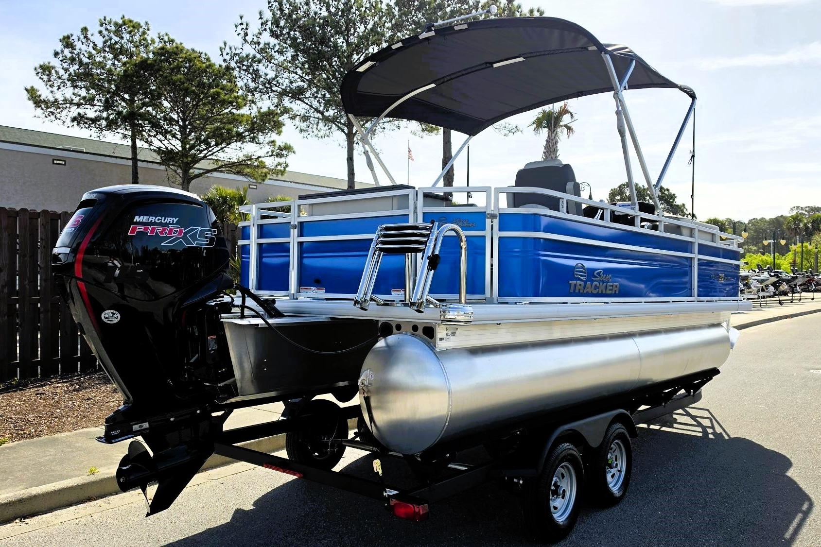2026 Sun Tracker Fishin' Barge 20 DLX pontoon boat with Mercury Pro XS engine.