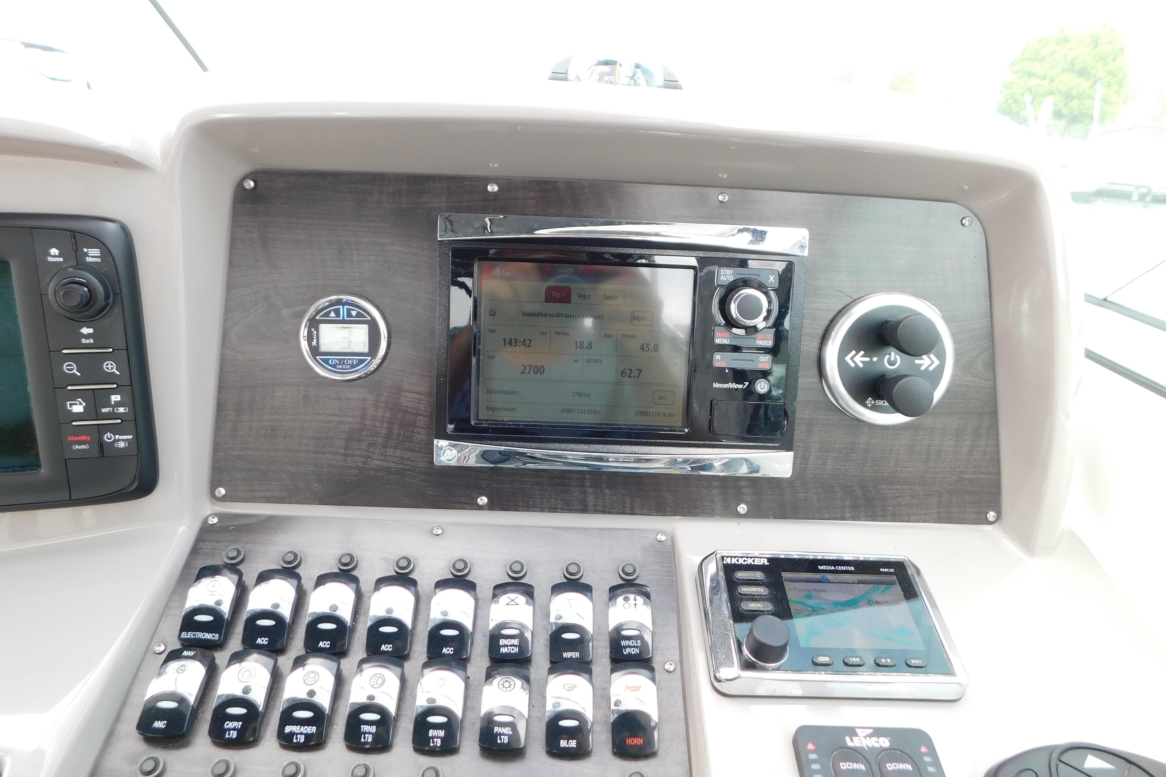 Control panel of a 2017 Rinker EX 320 boat with navigation and audio systems.