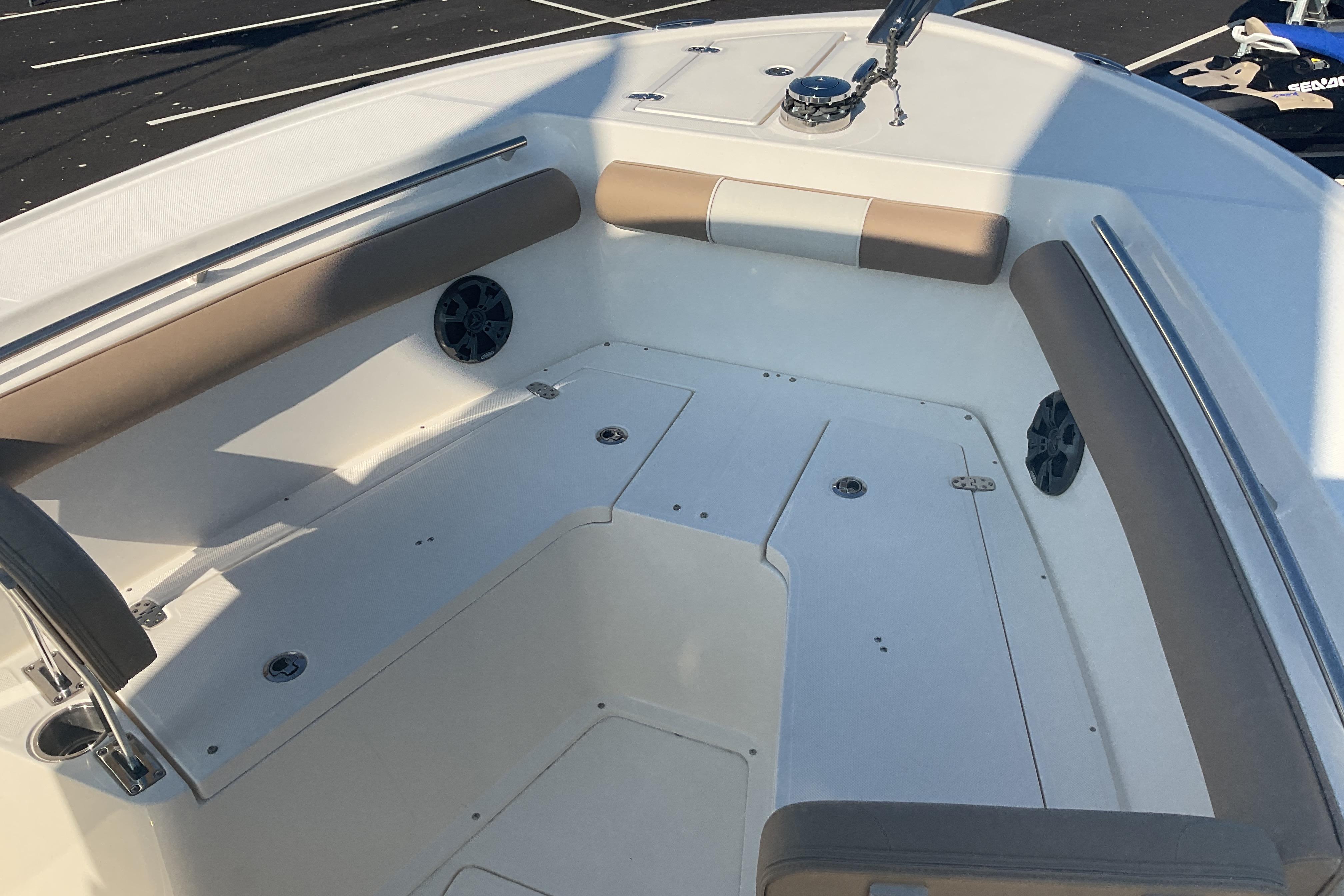 2023 Sea Born SX239 Offshore boat interior with cushioned seating and speakers.
