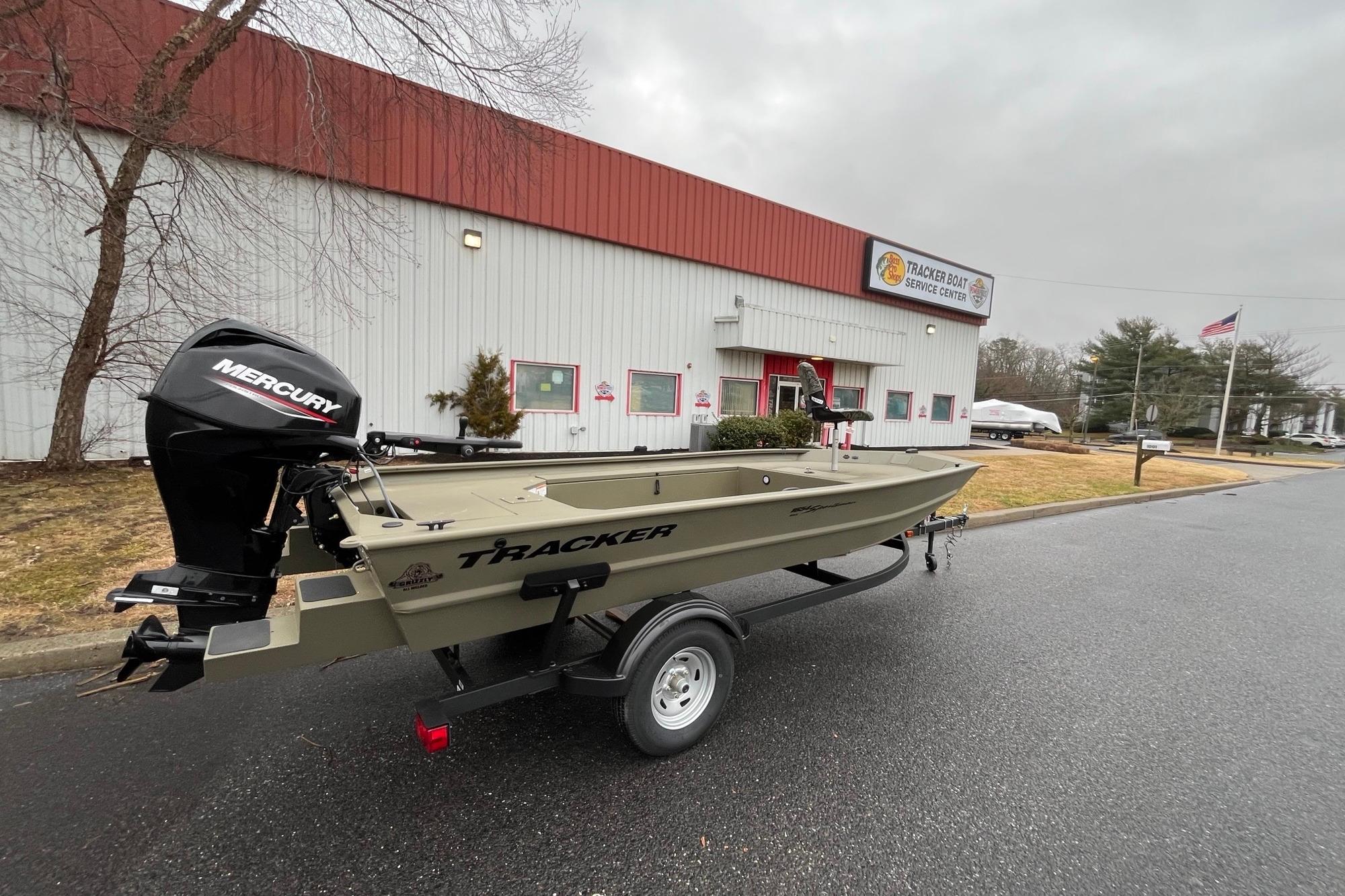 2026 Tracker Grizzly 1654 T Sportsman boat on trailer outside service center.