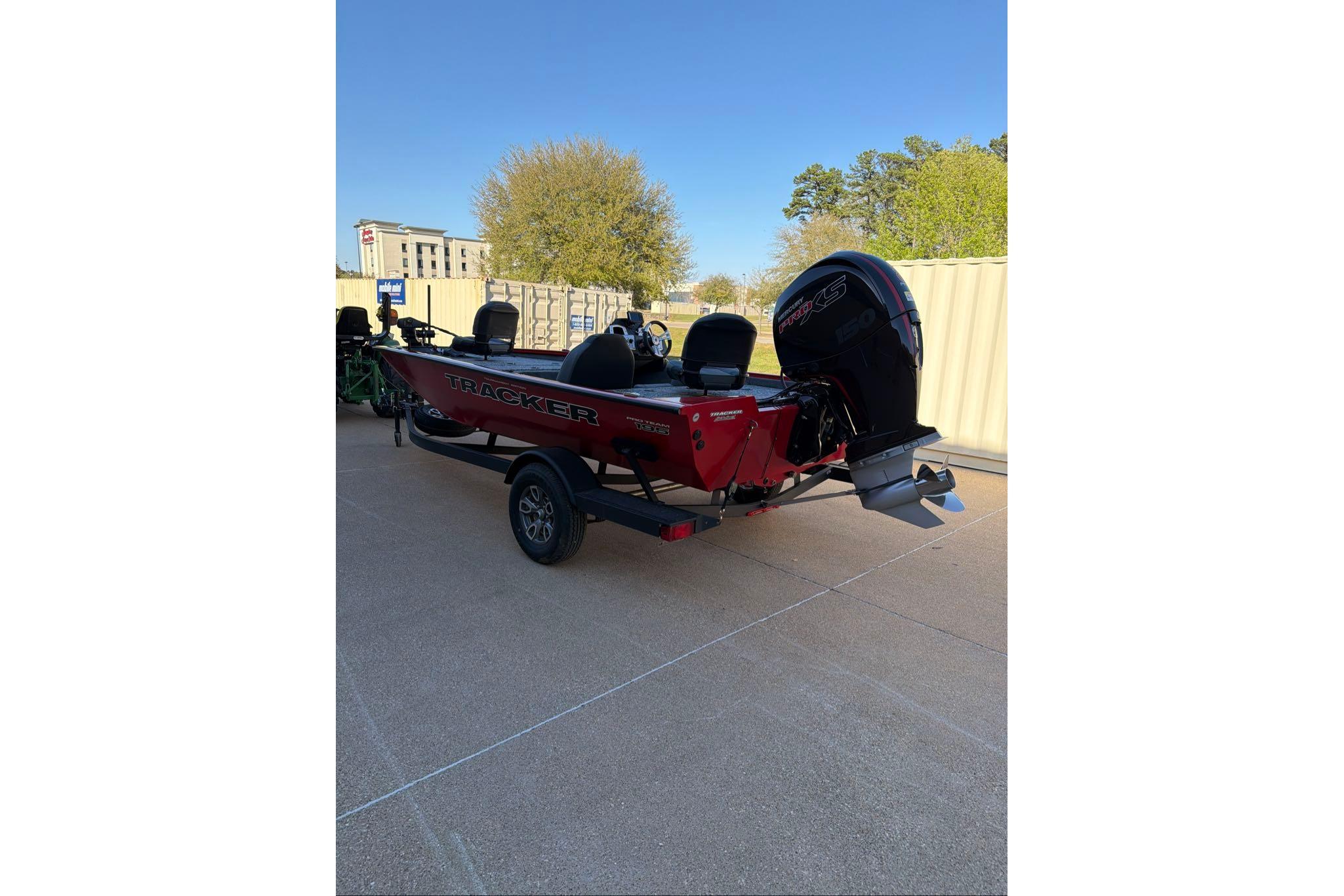 2026 Tracker Pro Team 195 boat on trailer, parked outdoors under clear sky.