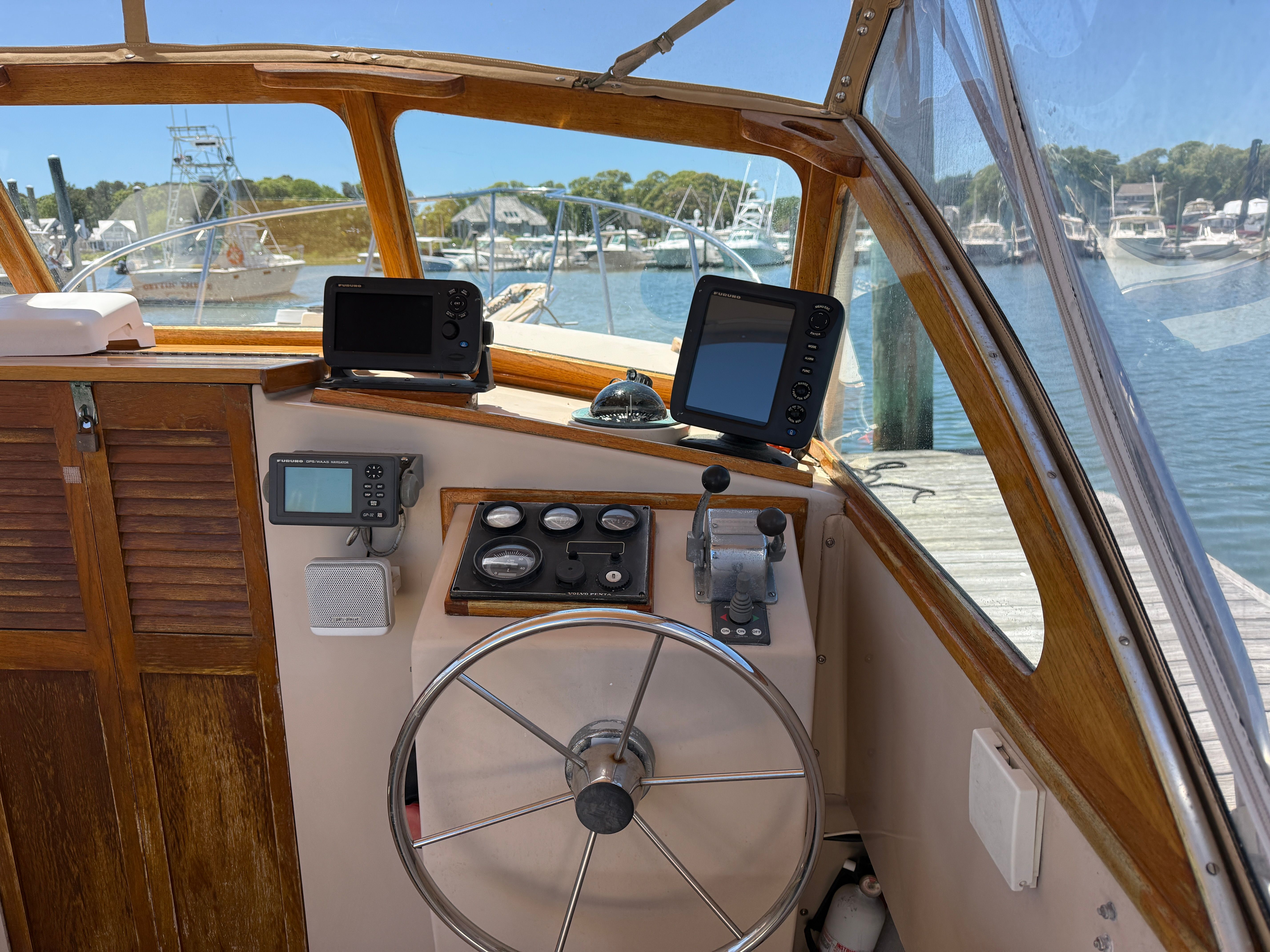 The cockpit of a 1989 Fortier 26 boat with a steering wheel and instruments.