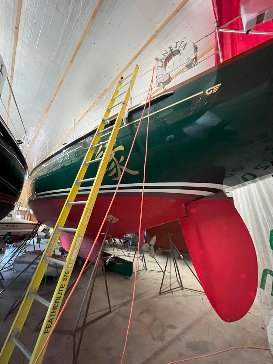 2001 Hinckley Sou'wester 59 CC sailboat in storage, with ladder and red keel visible.