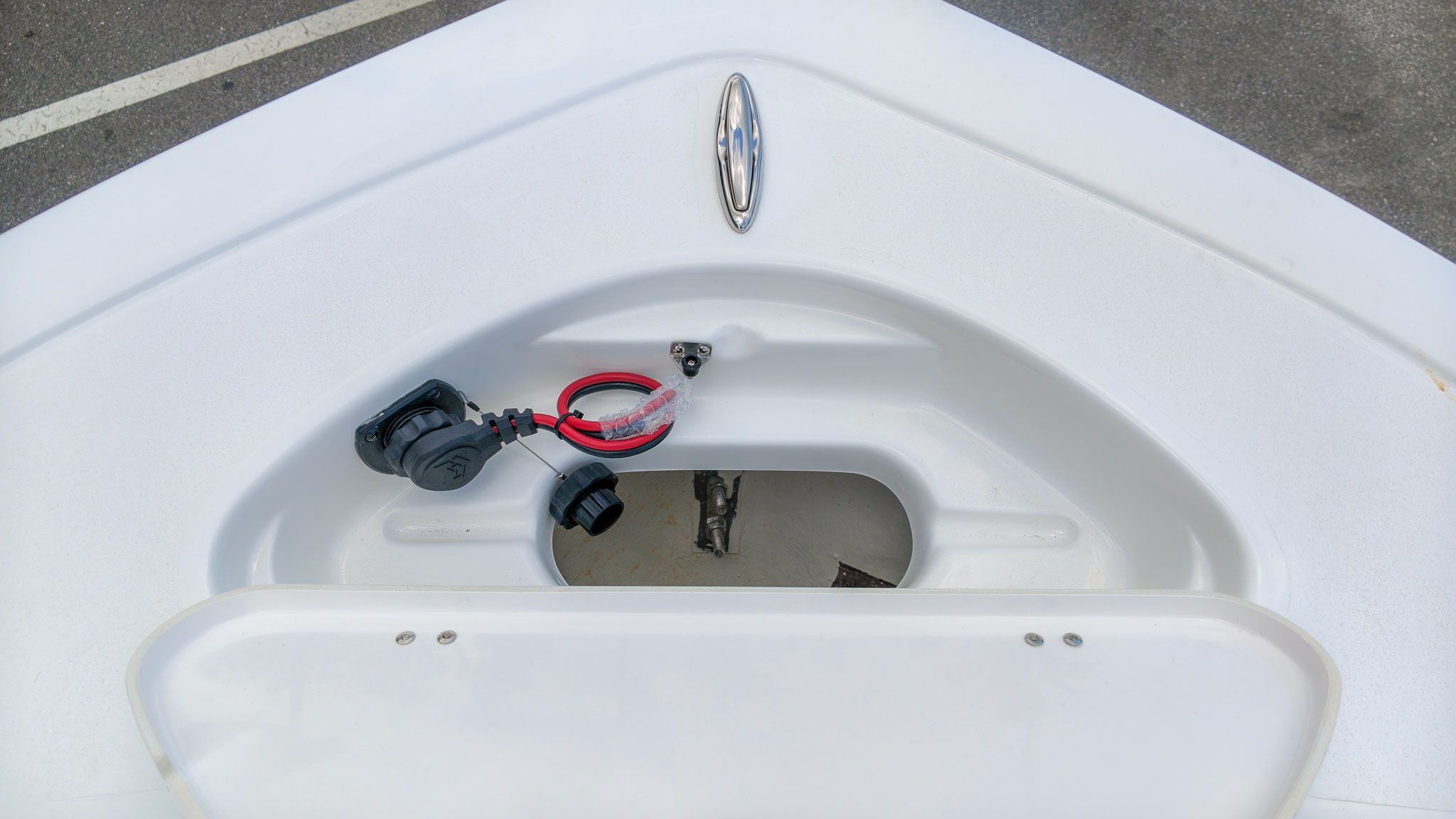 Front storage compartment of a Tidewater 198 CC Adventure boat with cables and cover.
