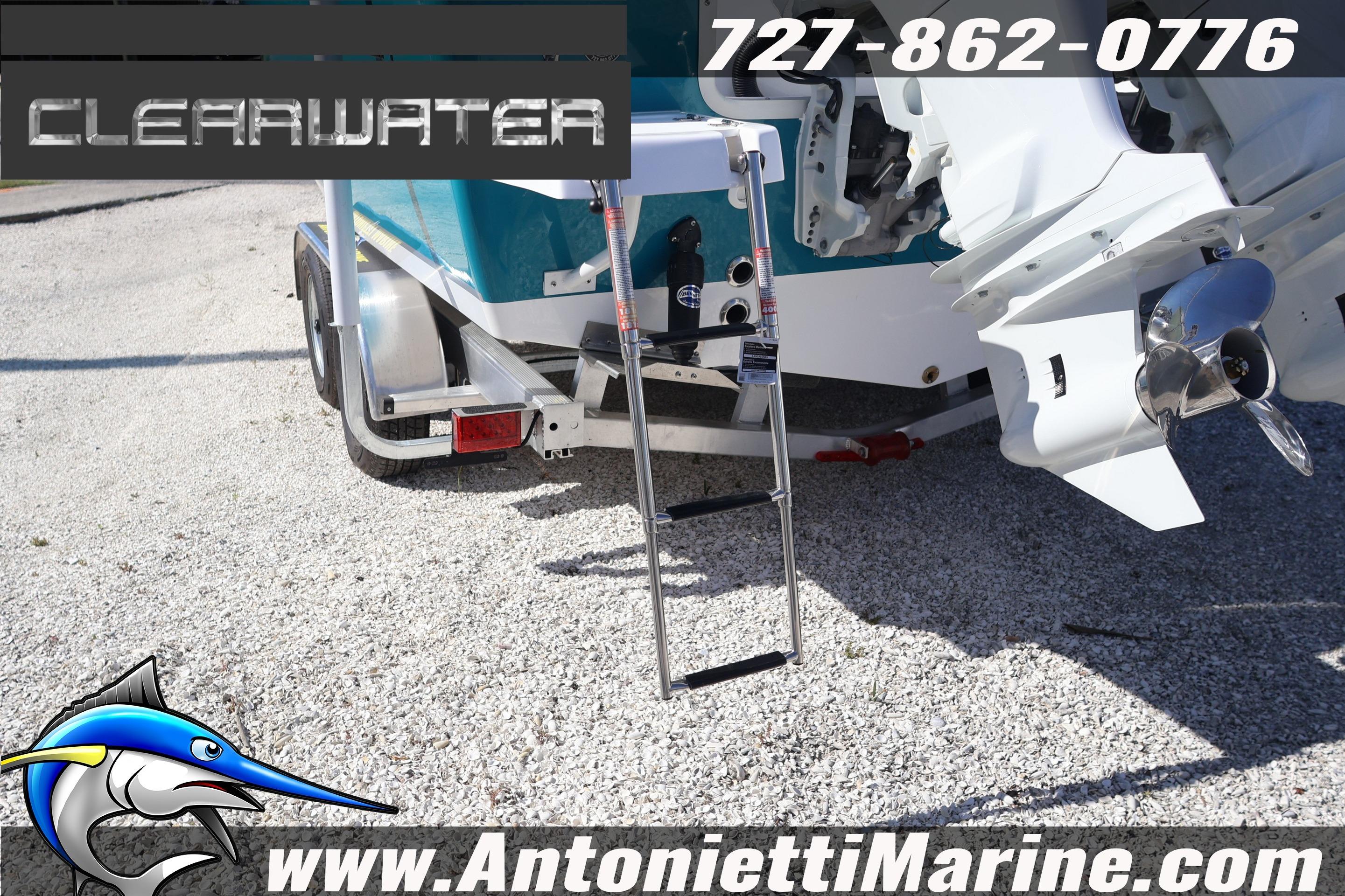 Clearwater 2300 boat on trailer, featuring outboard motor and ladder, 2026 model.