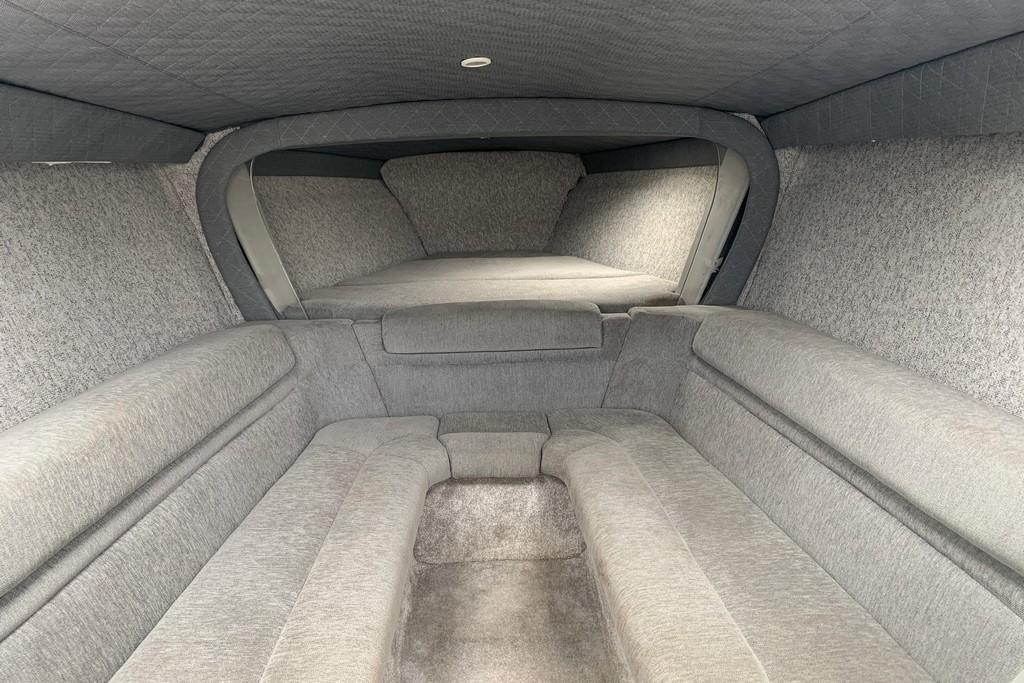 Interior cabin of a 1999 Formula 382 FASTech boat, featuring gray upholstery.