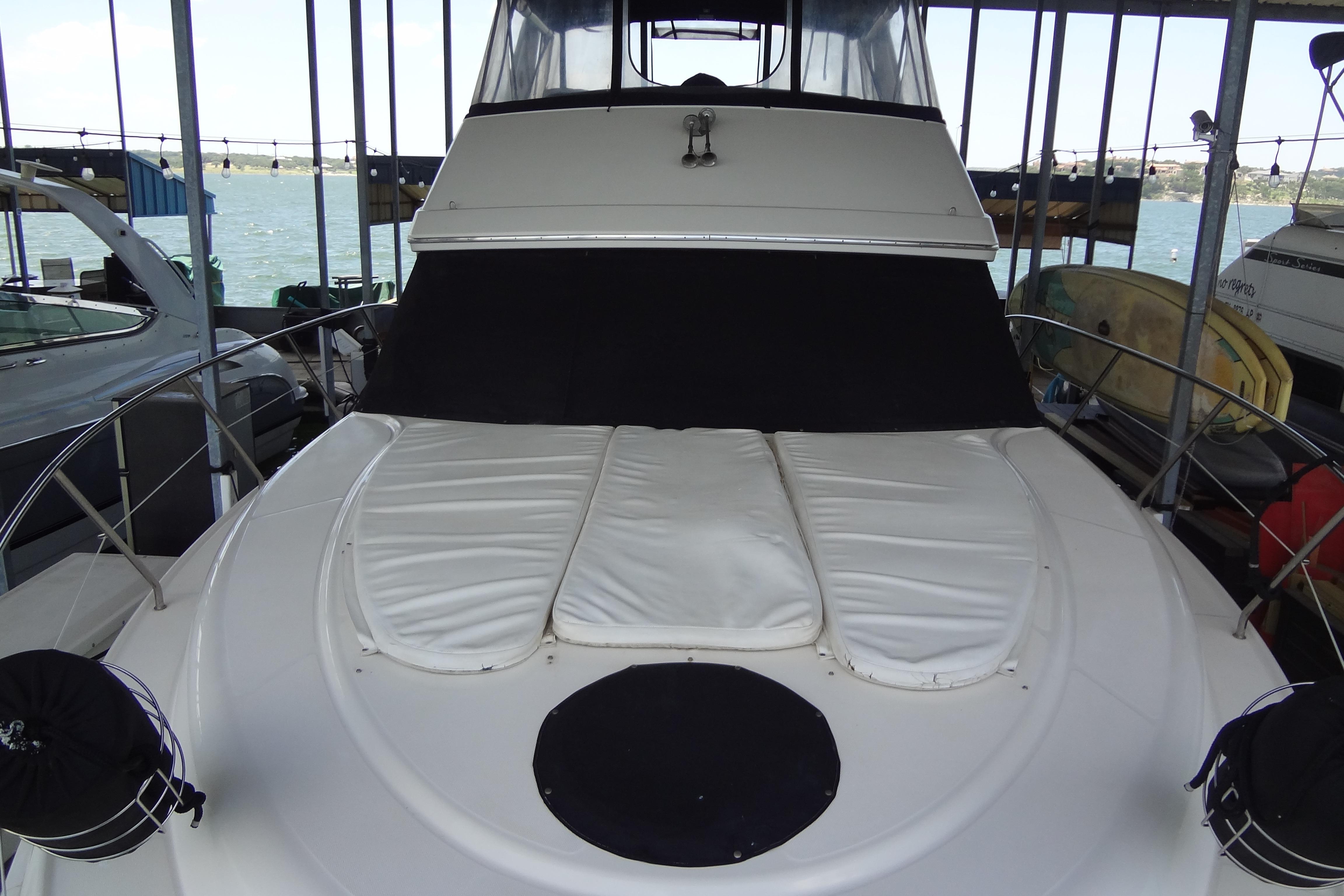 2005 Silverton 34 Convertible yacht docked, featuring a covered bow area.