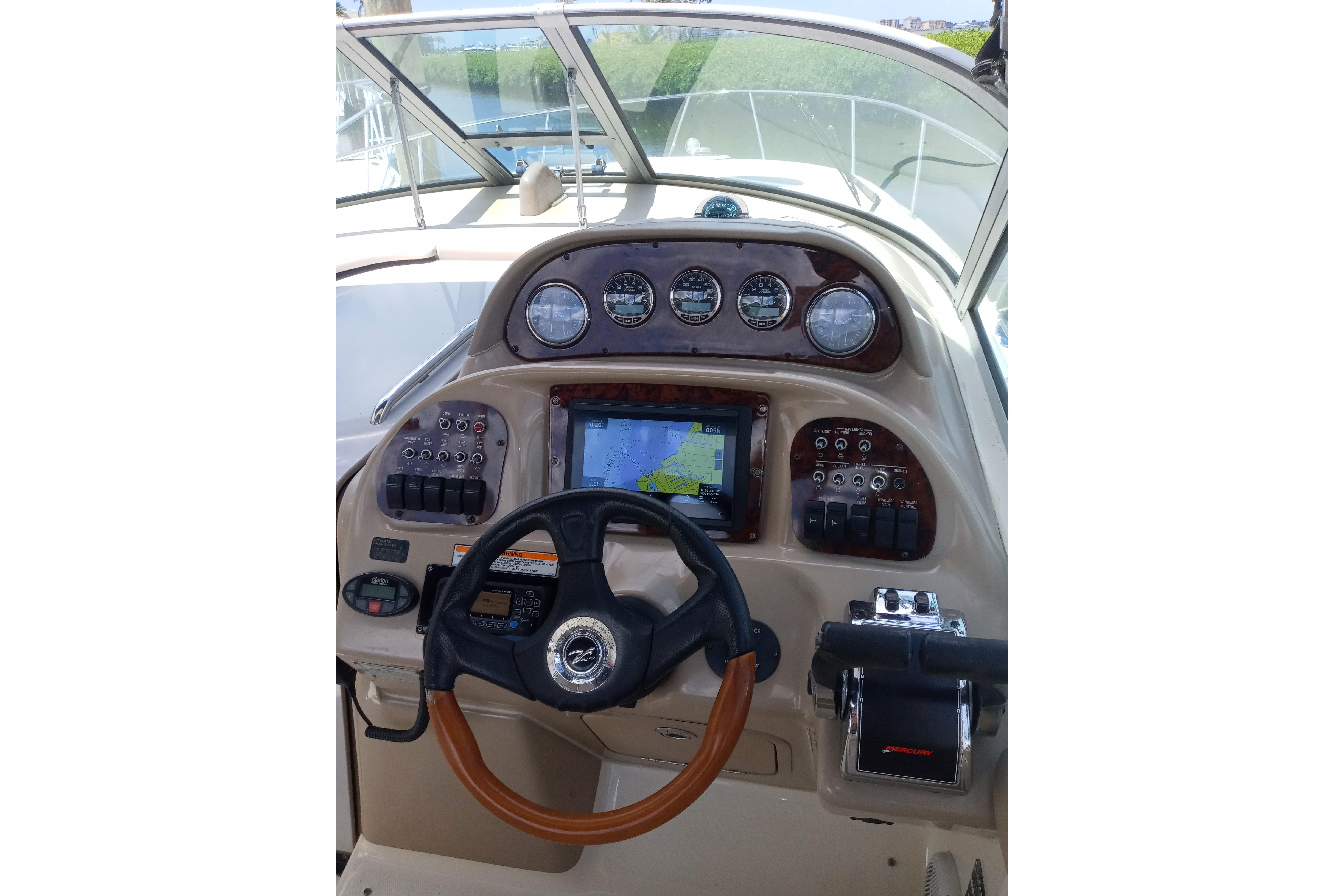 Helm of 2005 Sea Ray 300 Sundancer with navigation controls and gauges.