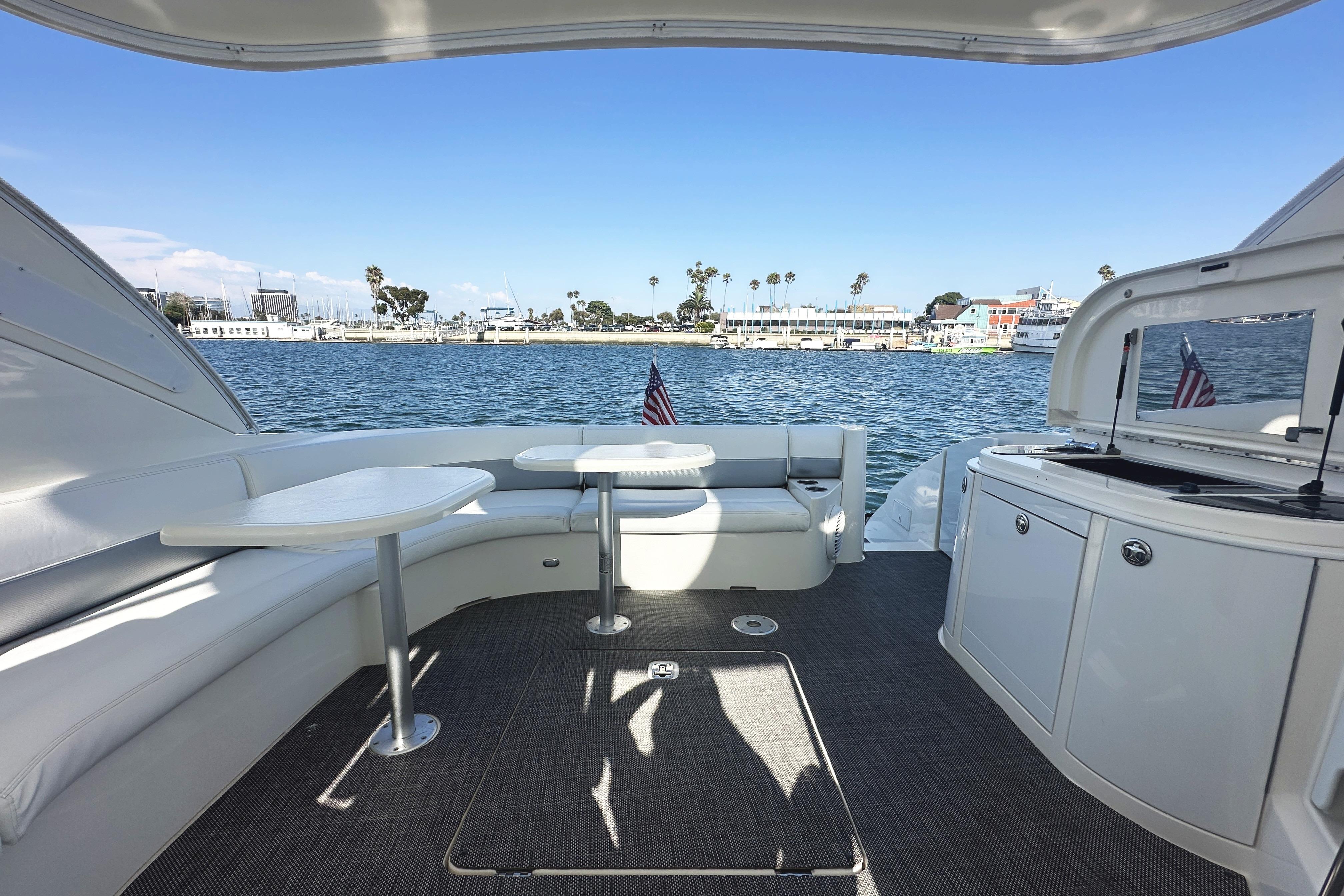 2007 Cruisers Yachts 540 Express interior with seating, tables, and waterfront view.