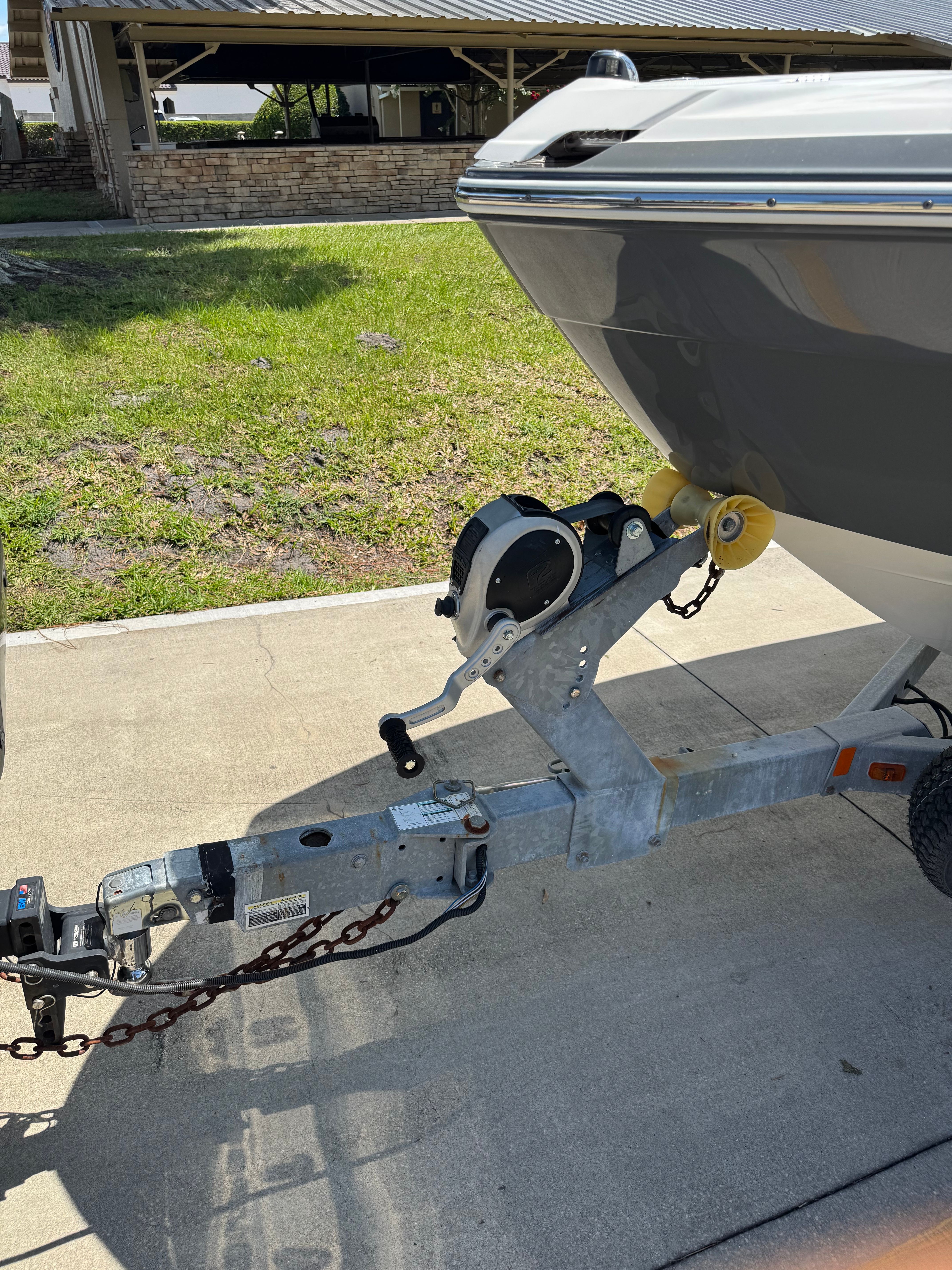 A 2015 Yamaha 242 Limited S boat on a trailer, ready for transport.