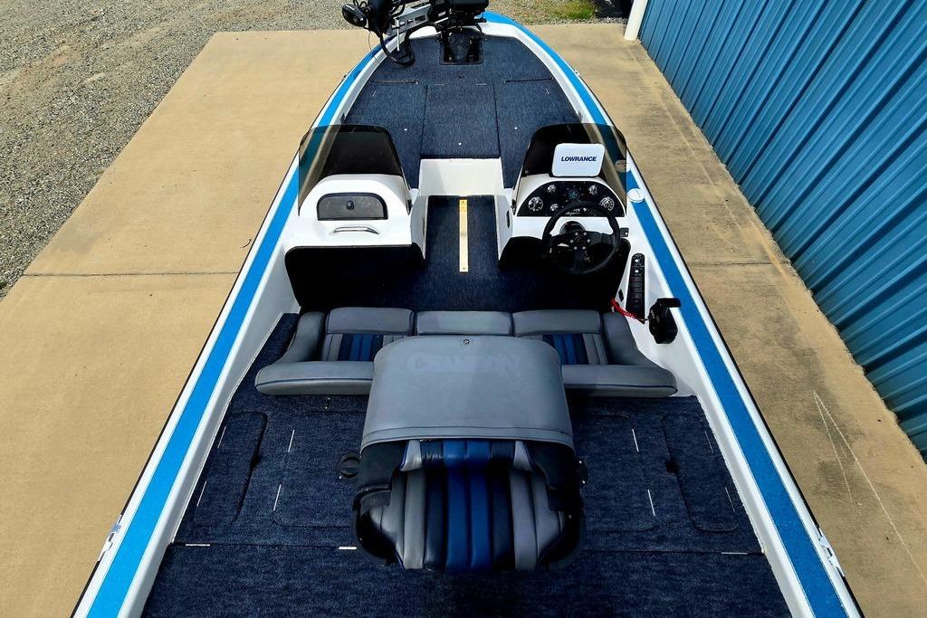 1996 Champion 181 SX boat interior with blue and gray seating, steering console, and Lowrance equipment.
