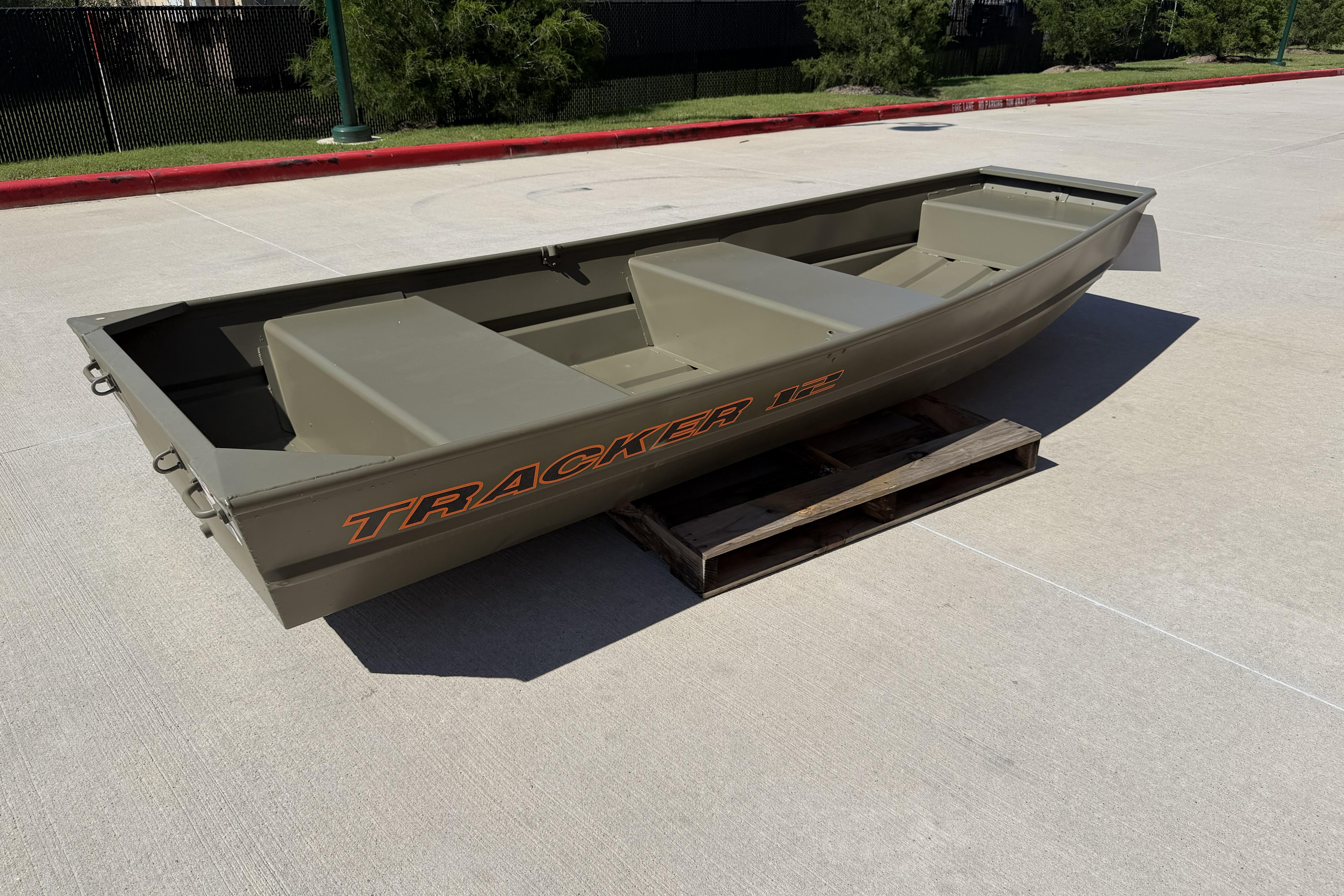 2026 Tracker Grizzly 12 Jon boat on a wooden pallet outdoors.