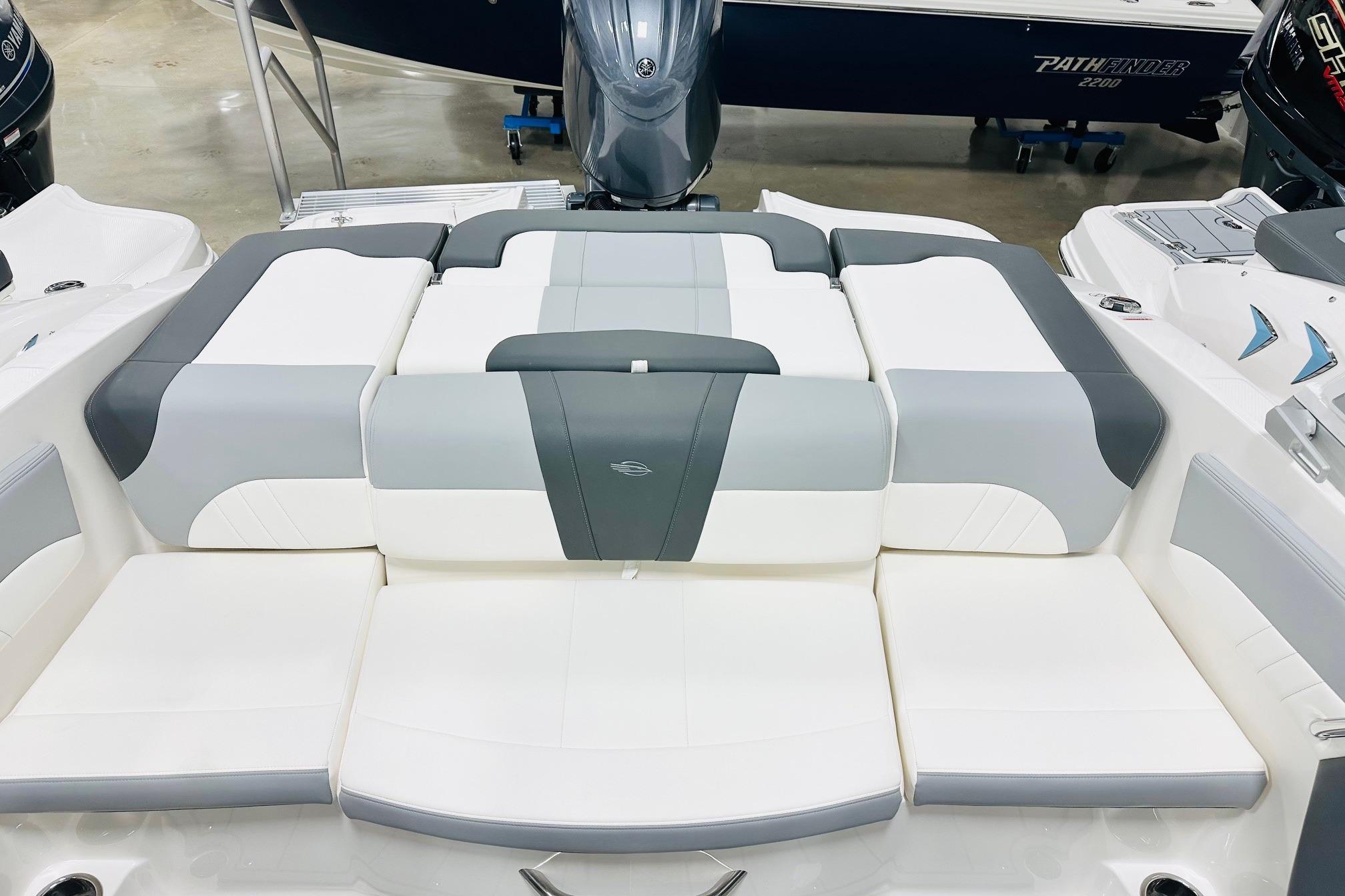 2025 Chaparral 21 SSi OB boat interior with gray and white cushioned seating.