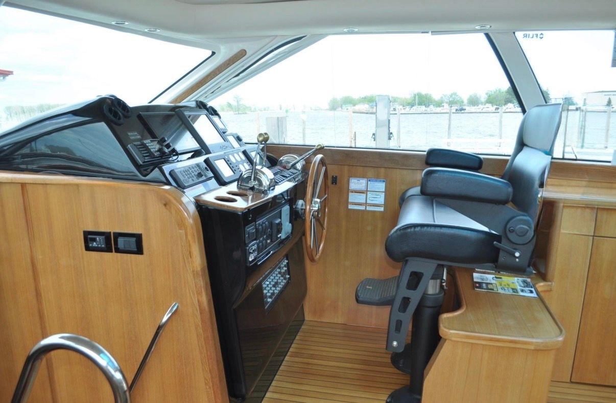 Interior of the 2005 Tiara Yachts 5200 Sovran with wood paneling and helm station.