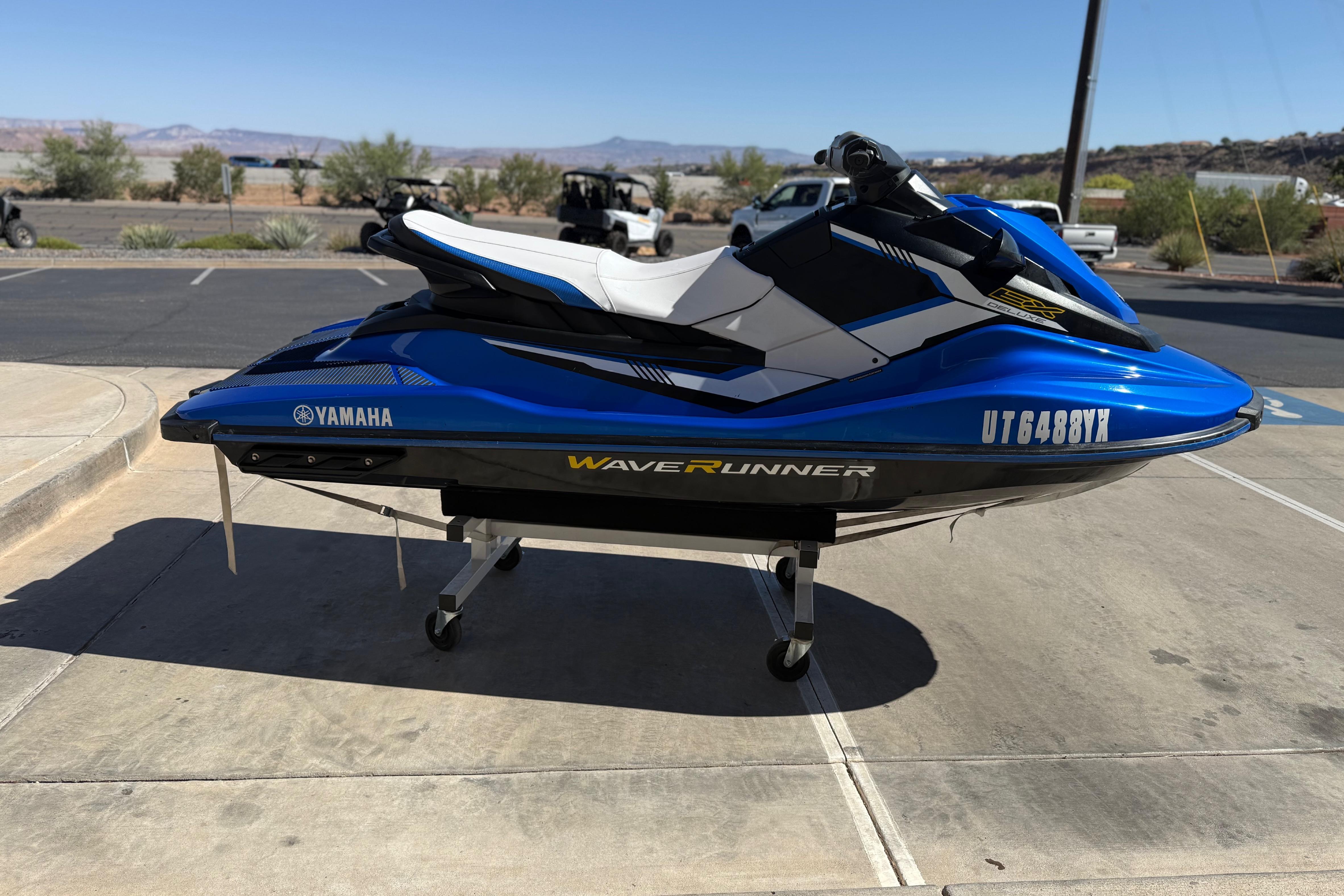 2017 Yamaha WaveRunner EX Deluxe in blue, parked on a concrete surface.