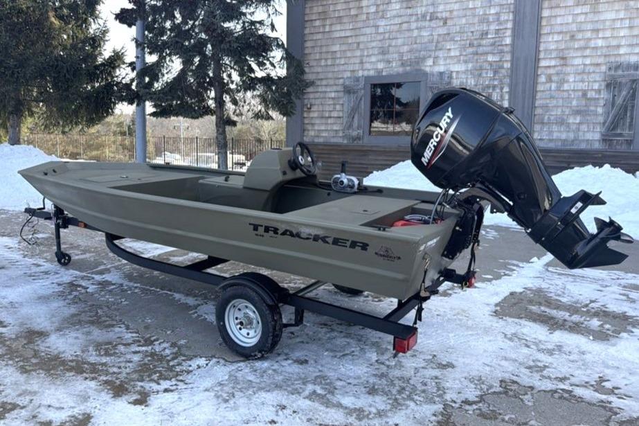 2026 Tracker Grizzly 1648 SC boat on trailer, parked on snowy ground.