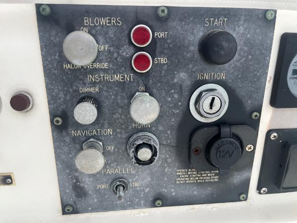 Control panel of a 1985 Hatteras 45 Convertible boat with ignition and navigation switches.