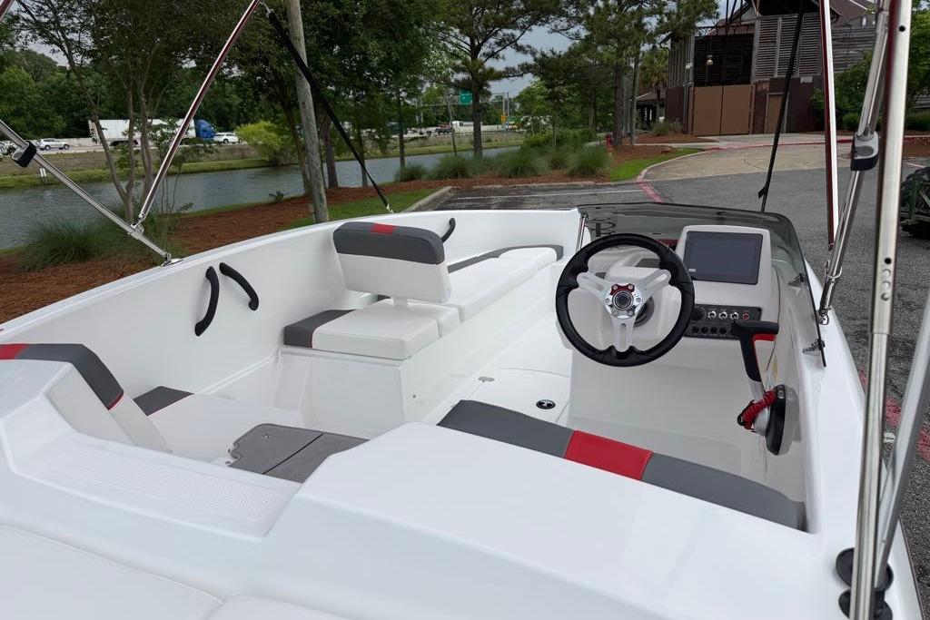 2026 Tahoe T16 boat interior with steering wheel, seating, and control panel.