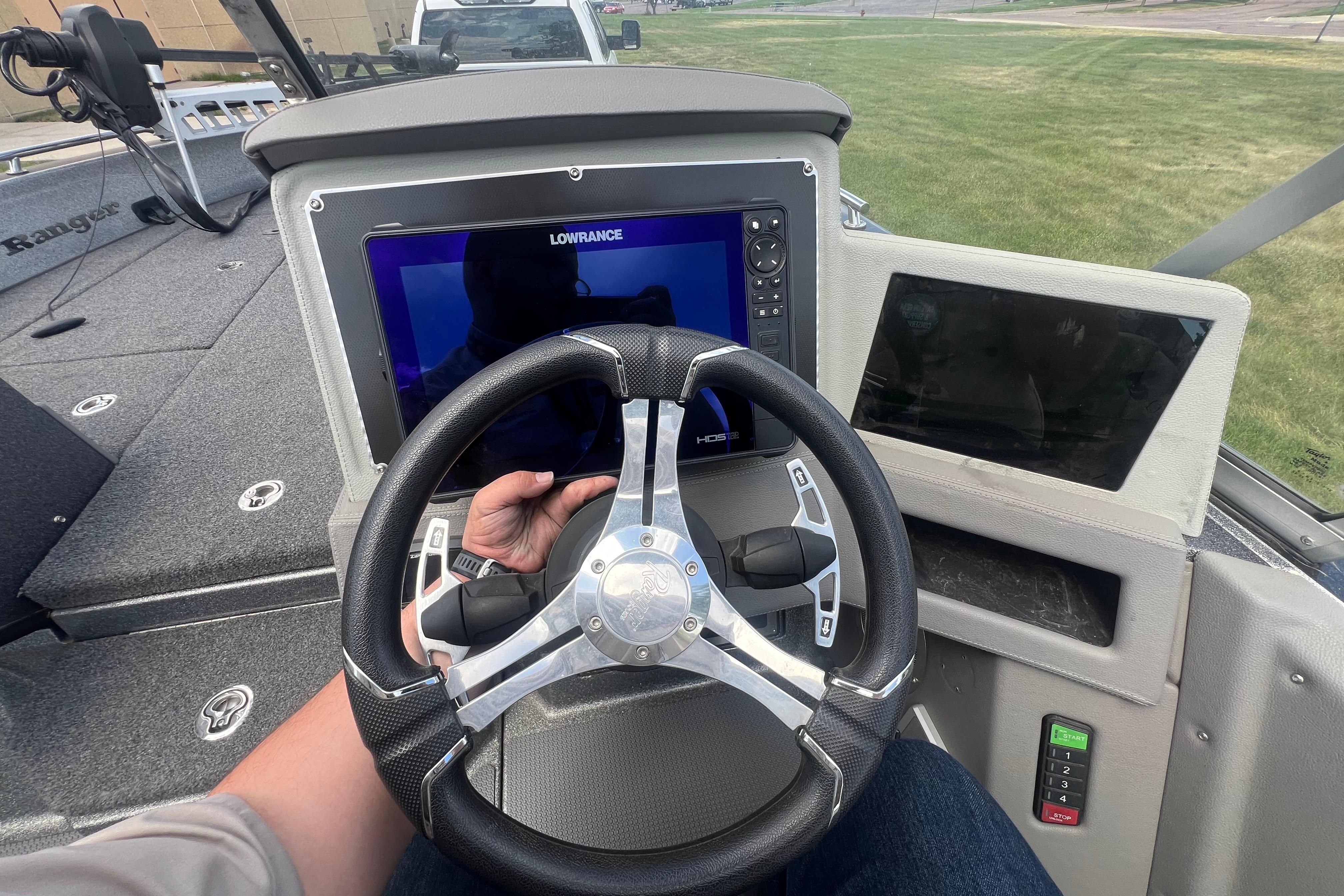 2023 Ranger 620FS Pro boat dashboard with steering wheel and Lowrance display.