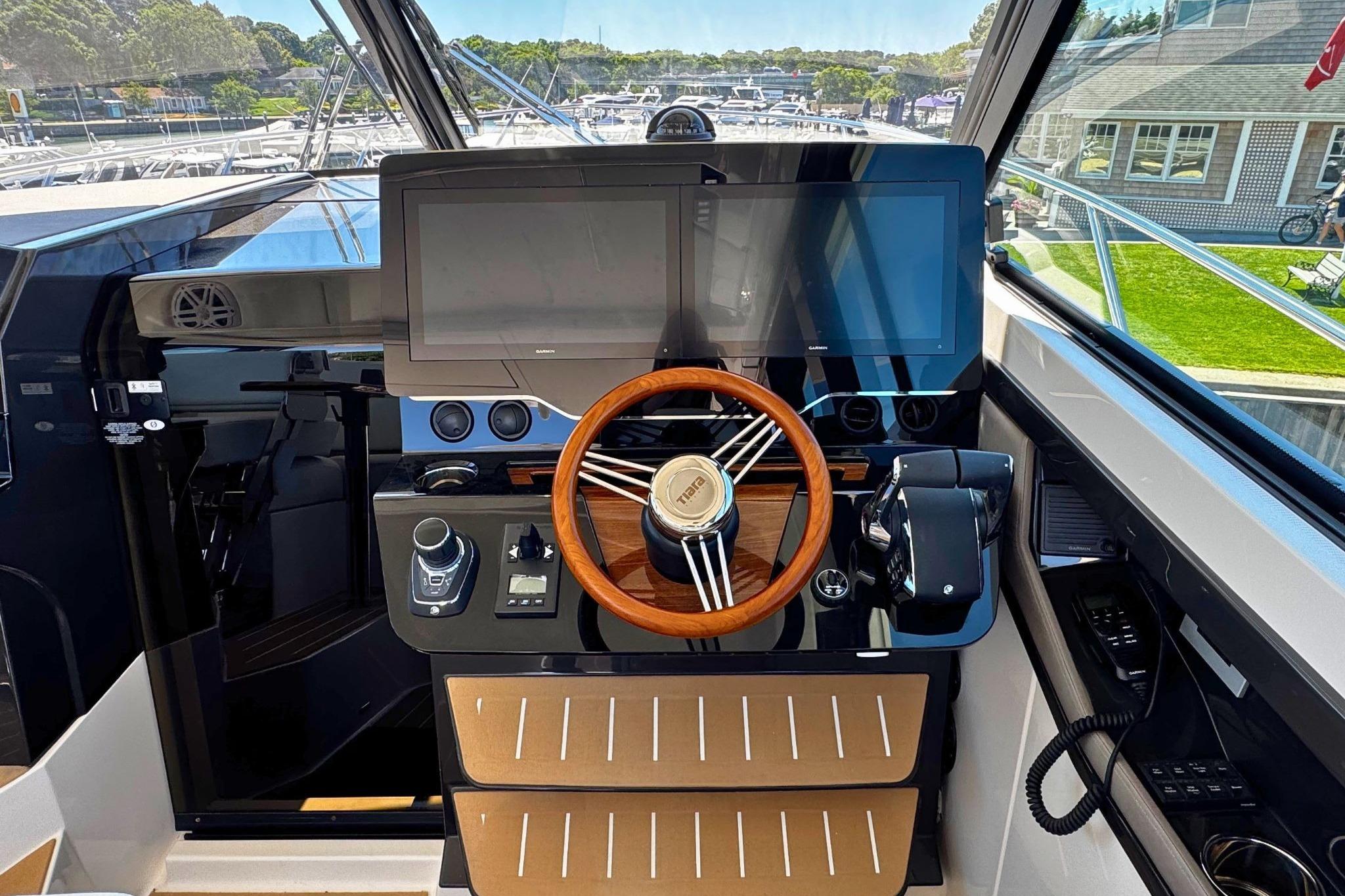 2027 Tiara Yachts 39 LE helm with modern controls and wooden steering wheel.