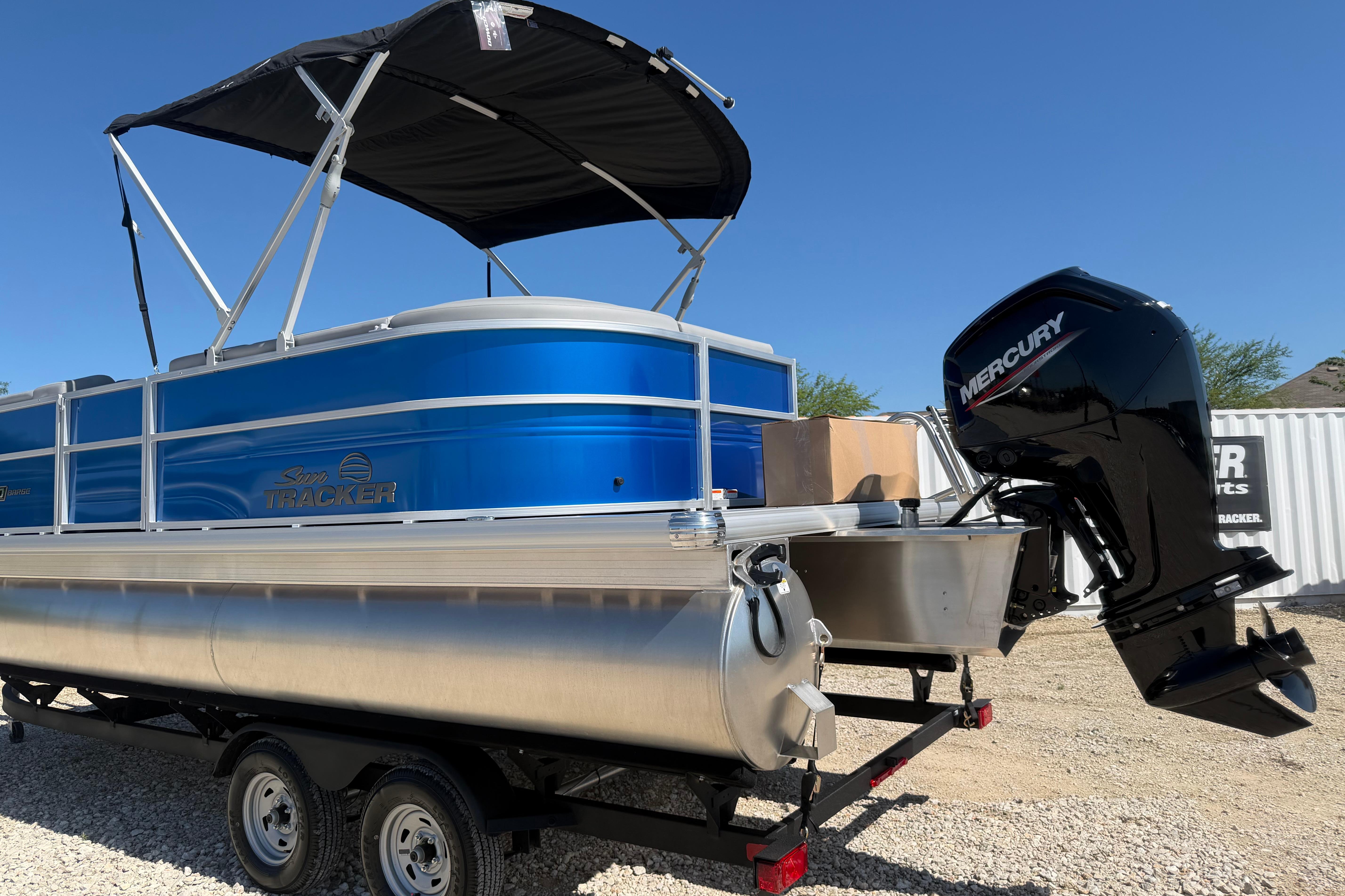 2026 Sun Tracker Party Barge 20 DLX pontoon boat with Mercury outboard motor.