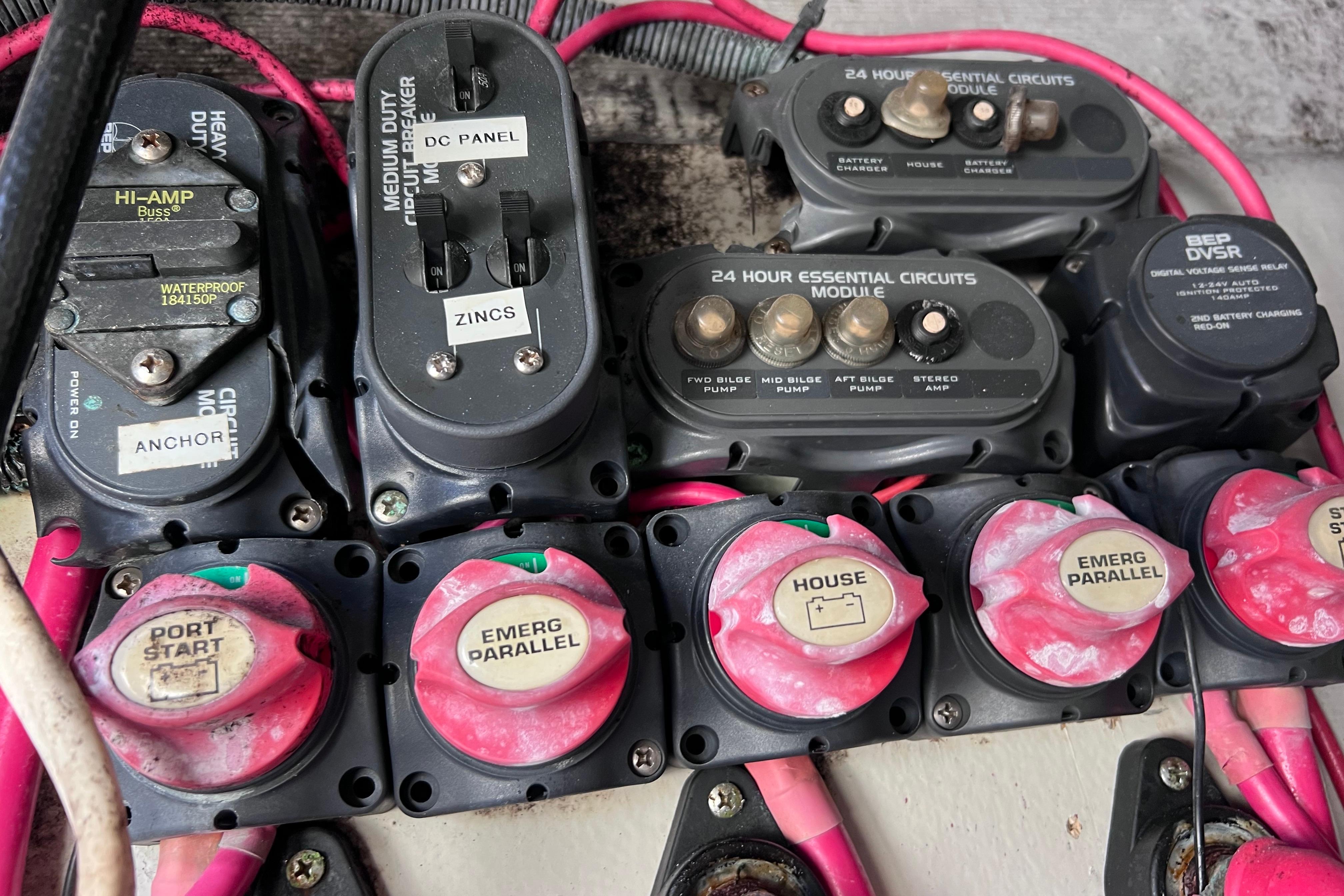 Electrical panel of a 2005 Pursuit 3070 Offshore boat with circuit breakers and switches.