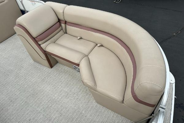 Beige upholstered seating on a boat with brown accents.