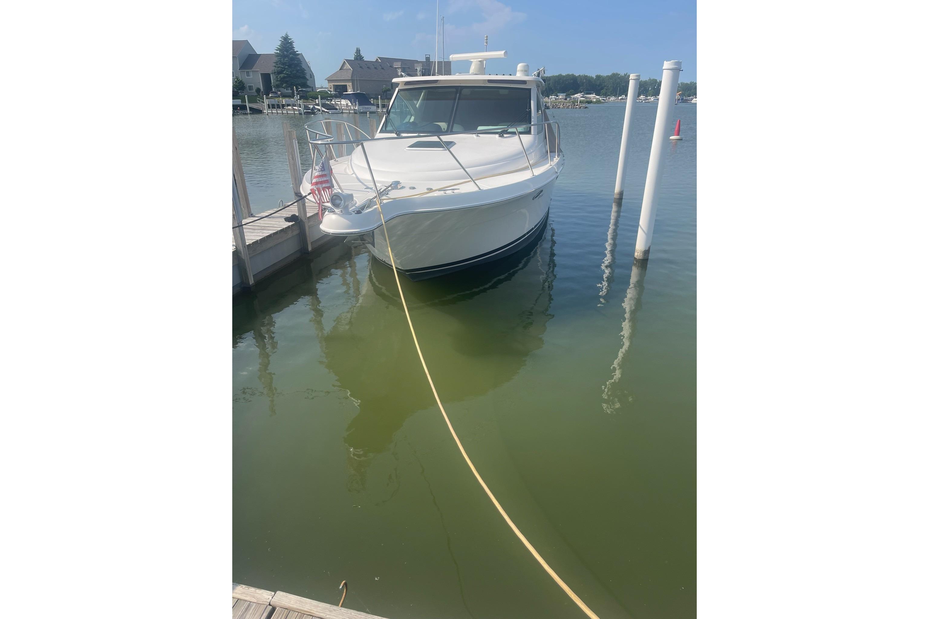 2013 Tiara Yachts 3100 Open docked in a marina, front view.
