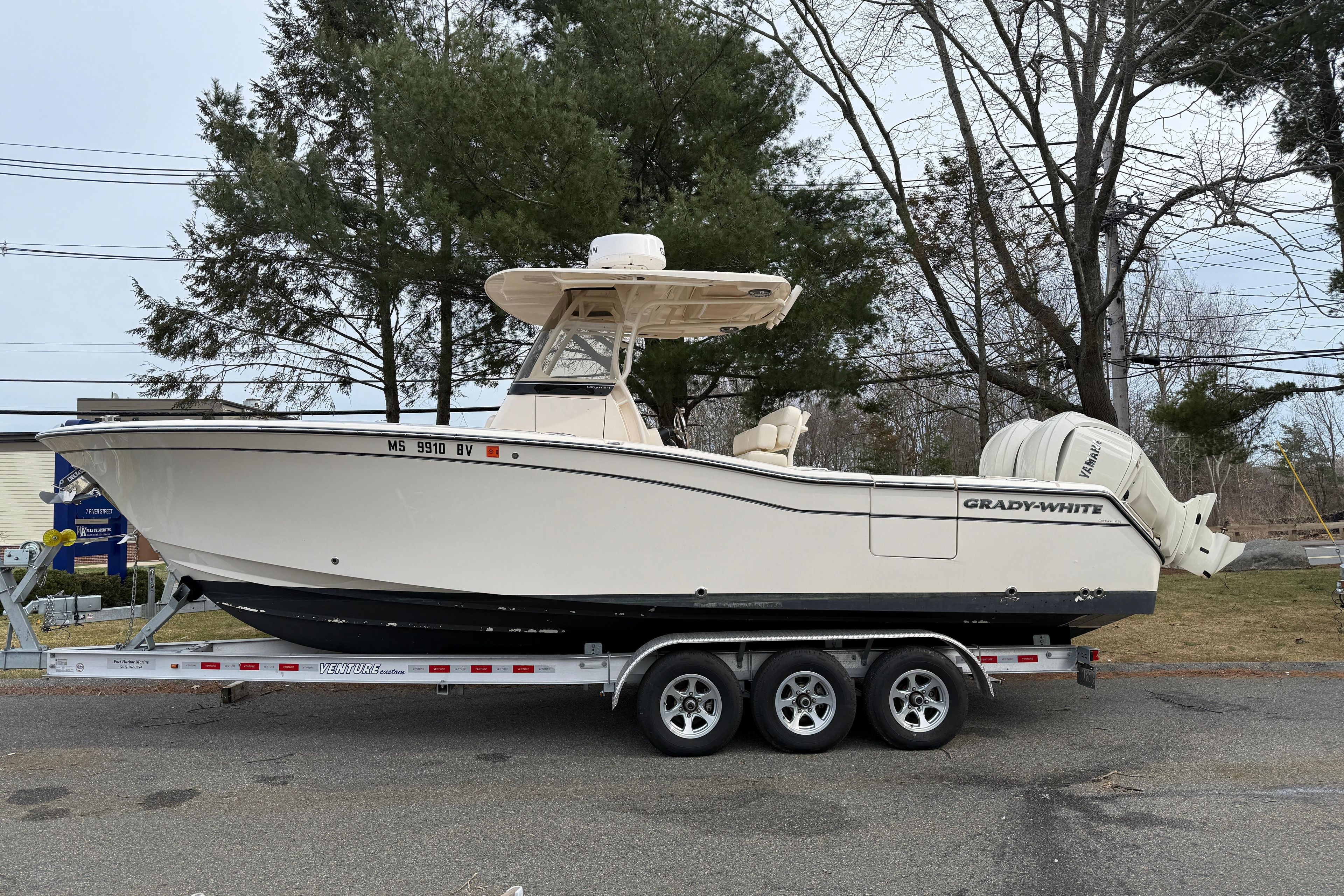 2024 Grady-White Canyon 271 boat on trailer, parked outdoors.