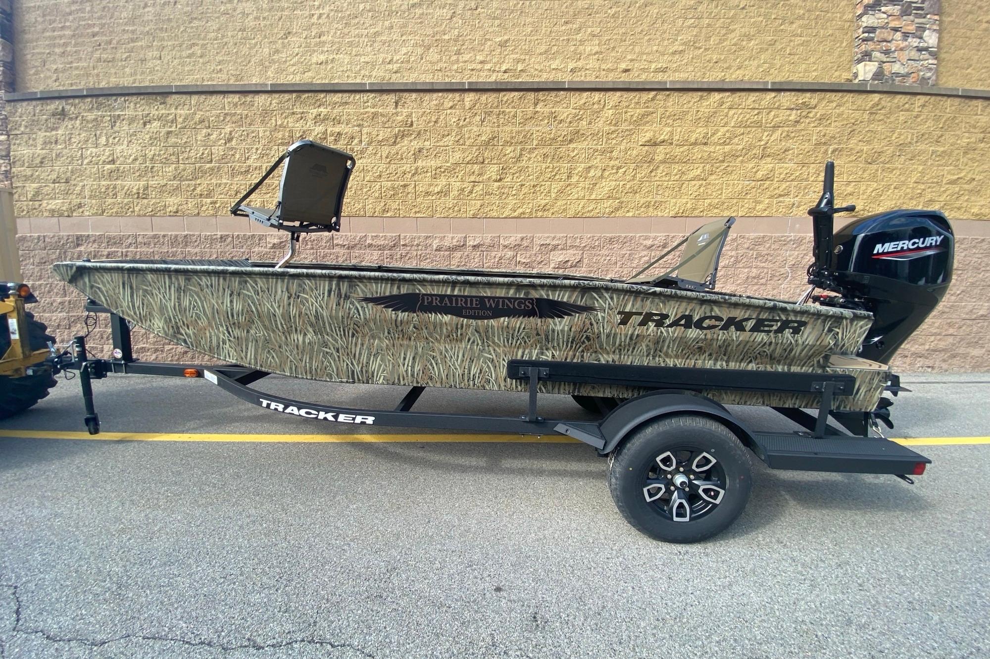 2026 Tracker Grizzly 1650 T Prairie Wings Edition boat on trailer, featuring camo design and Mercury engine.