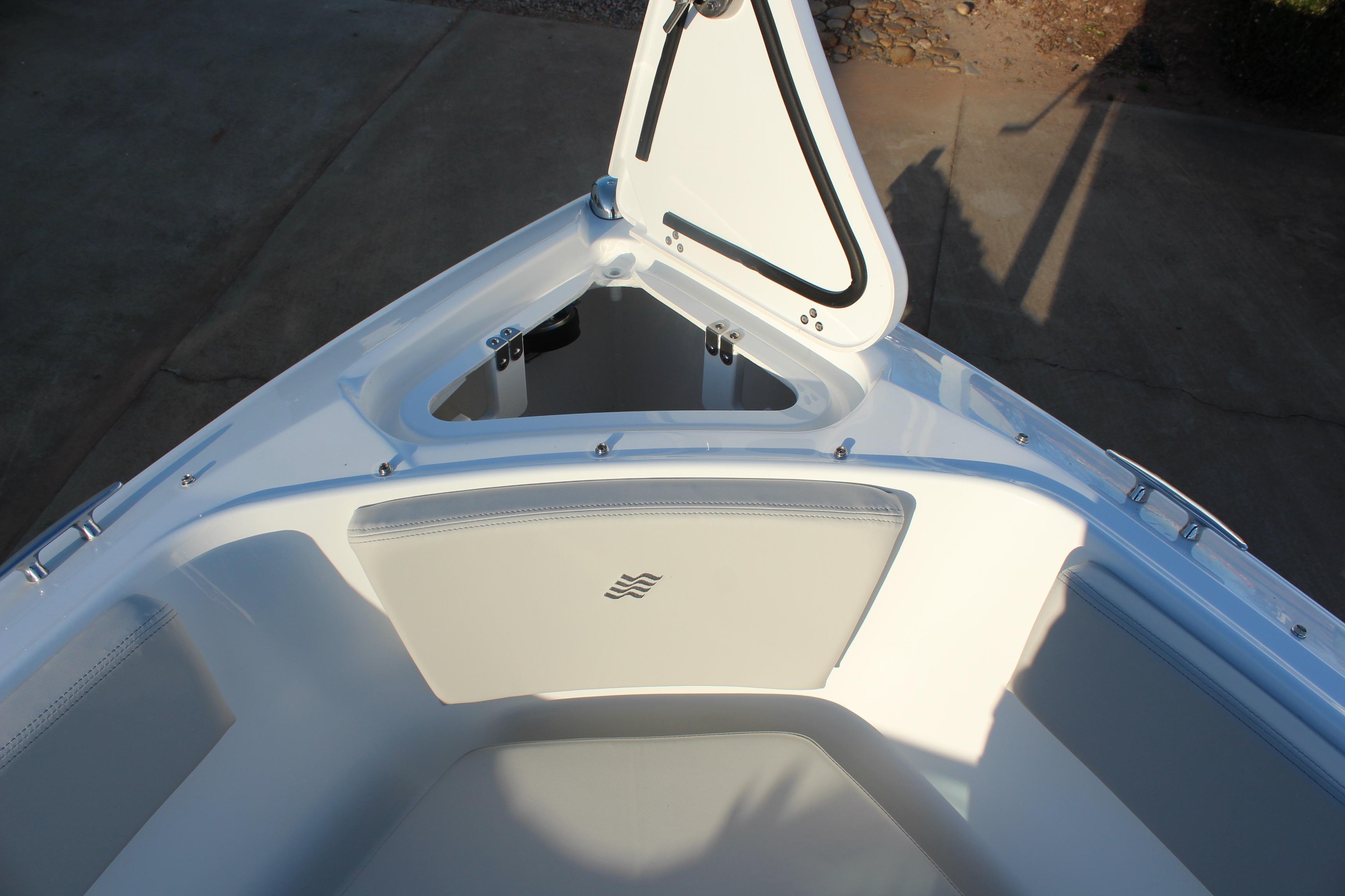2026 Four Winns H2 Freedom boat bow seating with open storage compartment.