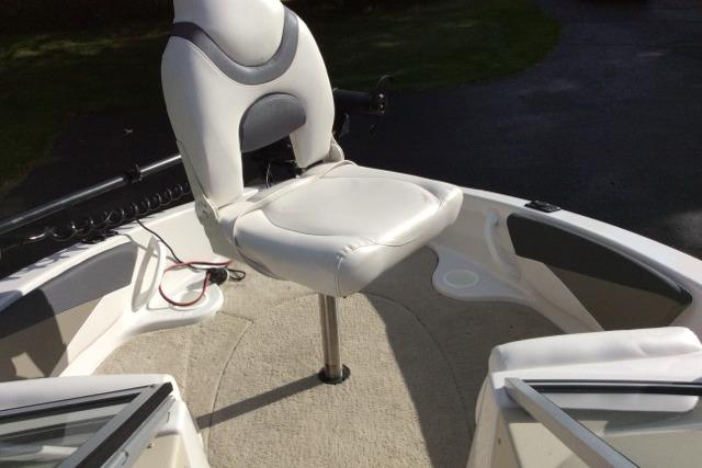 2012 Glastron GT180 boat interior with white swivel seat and carpeted deck.