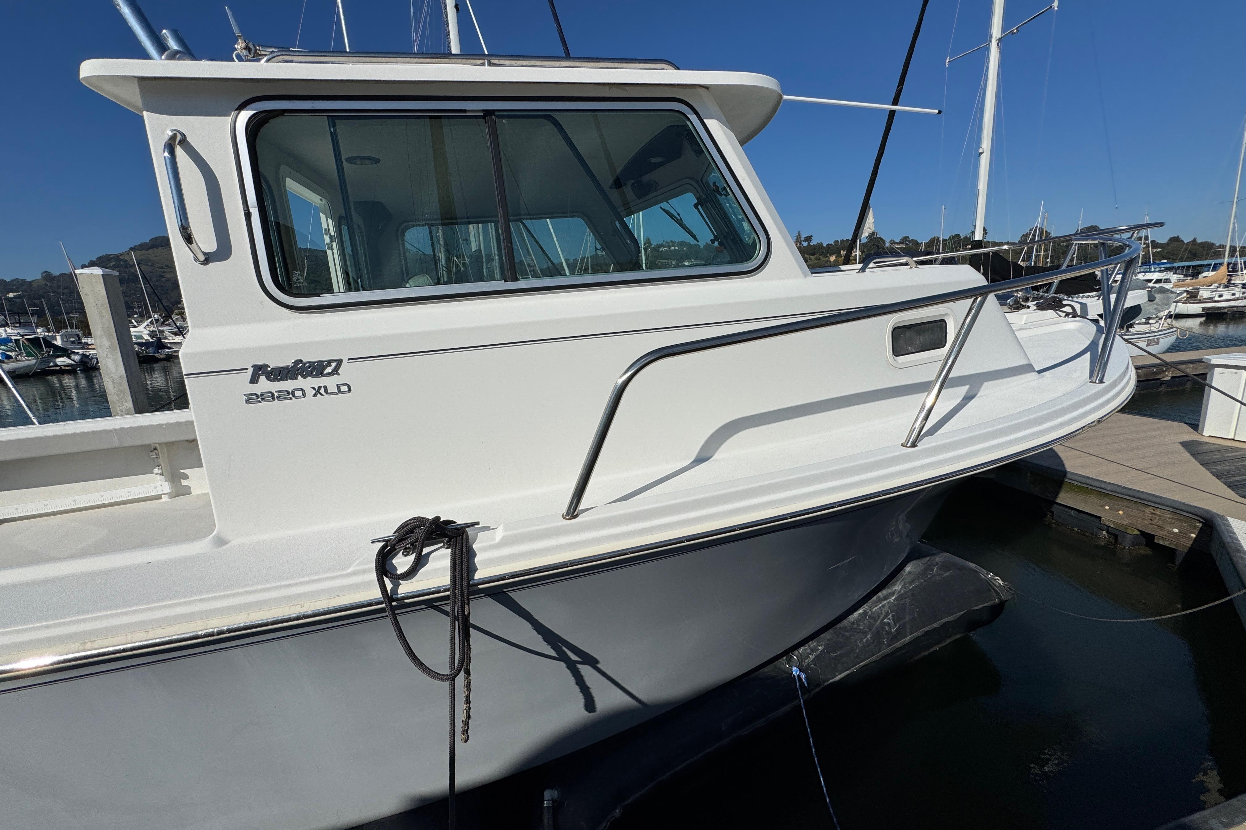 2021 Parker 2820 XLD Sport Cabin boat docked at marina, side view.