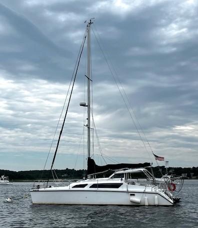 2010 Gemini 105Mc catamaran sailing on a cloudy day, anchored in calm waters.